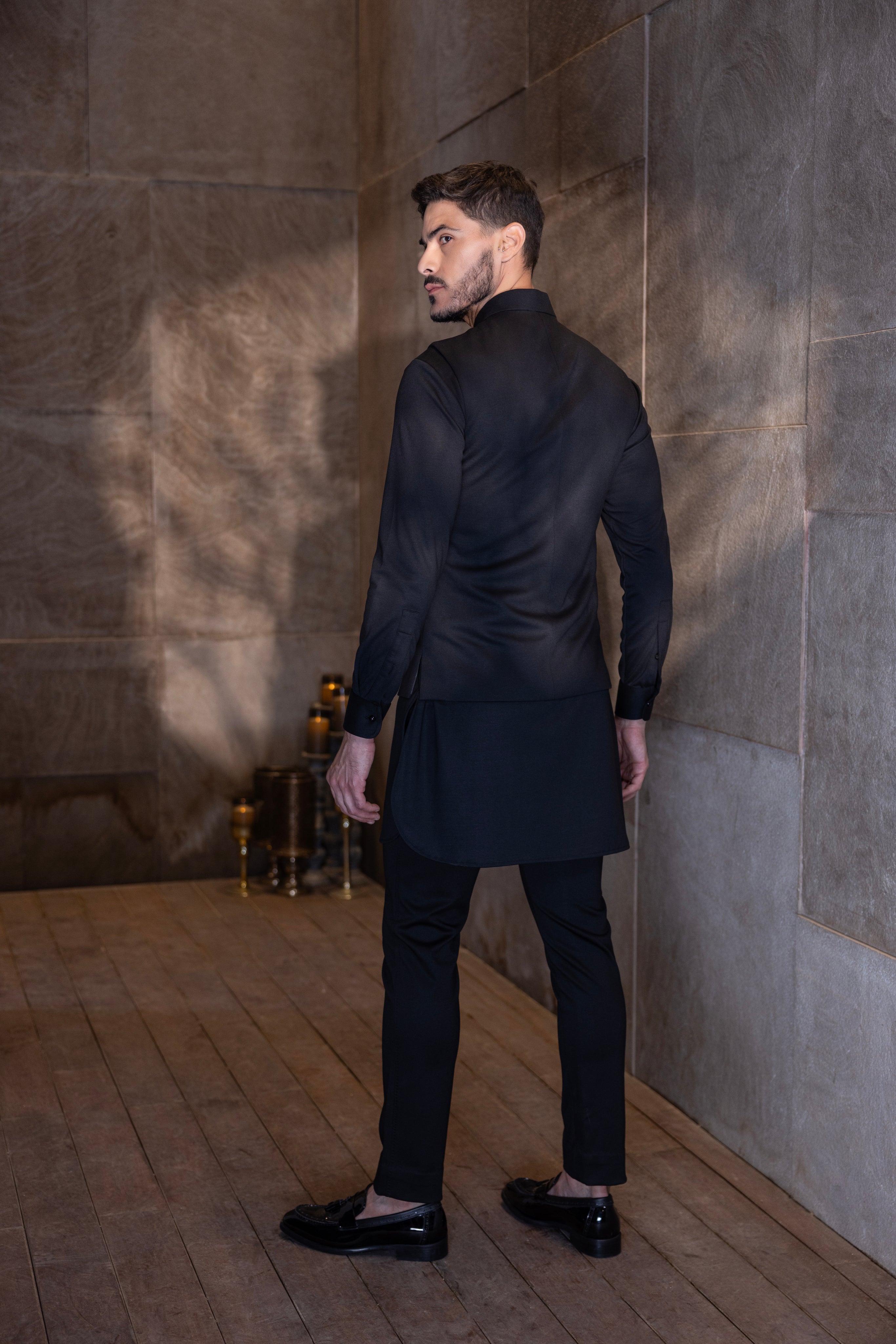 Black waistcoat with a hand-embroidered Bird motif paired with a matching kurta and aligadhi set.