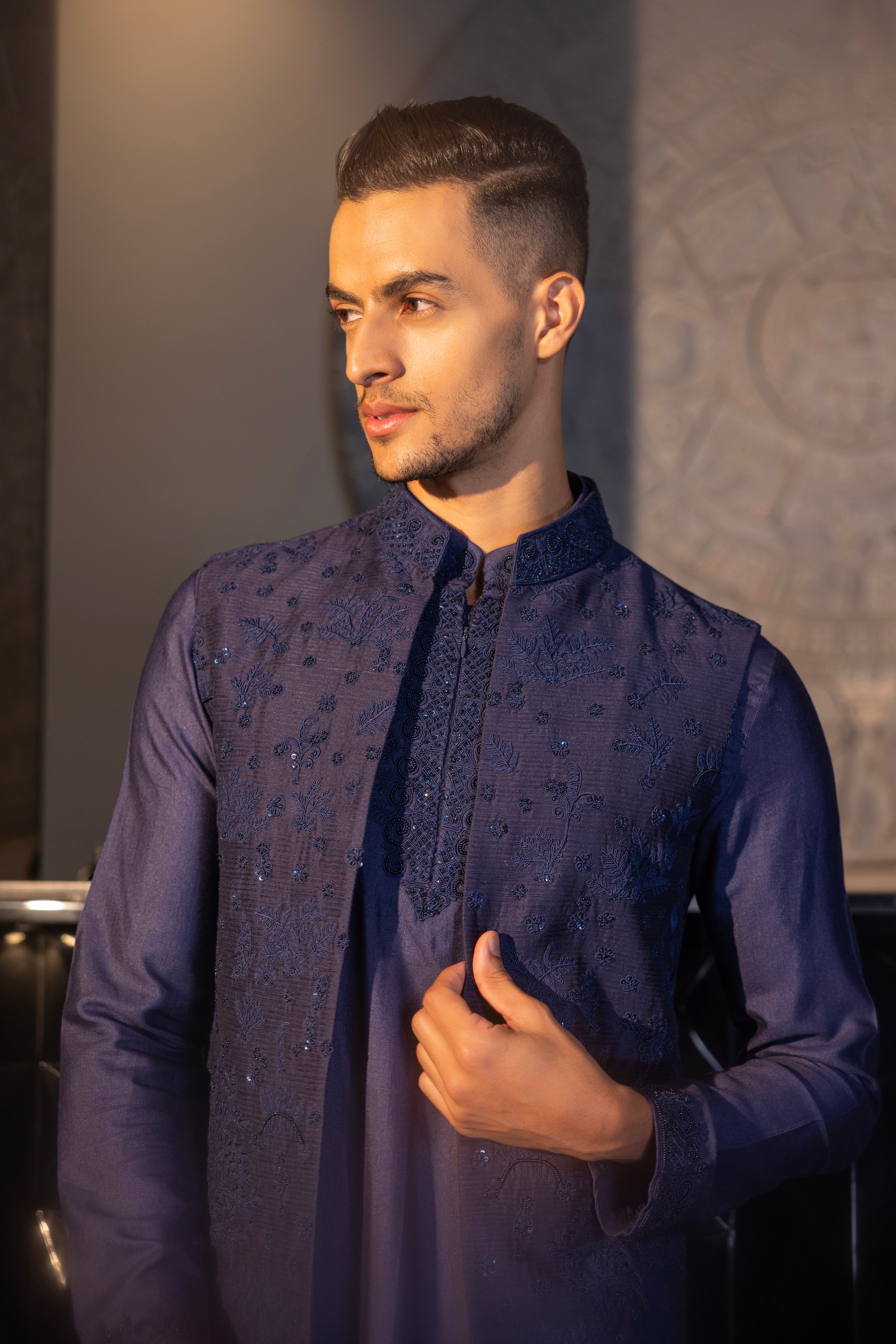 Banarasi Silk Navy Blue hand-embroidered waistcoat paired with an embroidered kurta and an aligadhi.