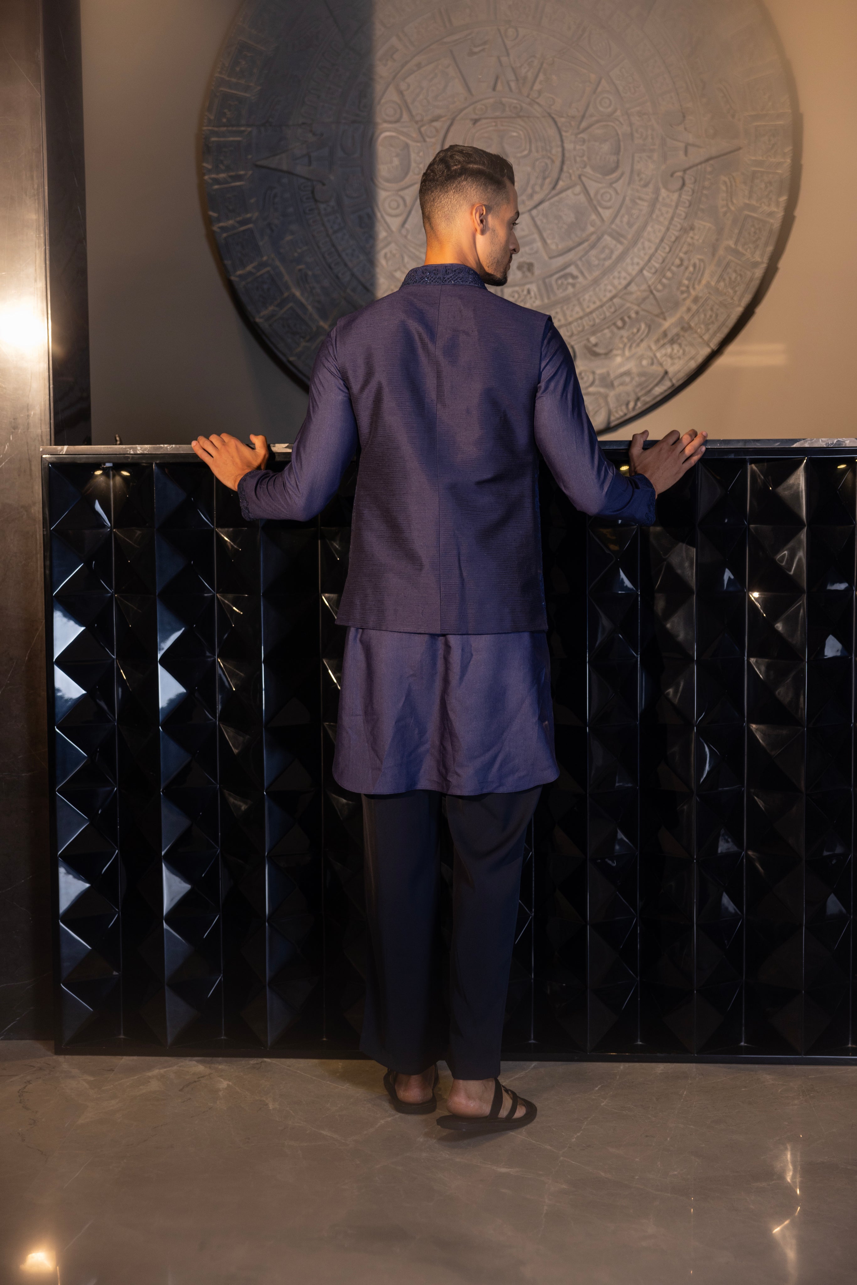 Banarasi Silk Navy Blue hand-embroidered waistcoat paired with an embroidered kurta and an aligadhi.