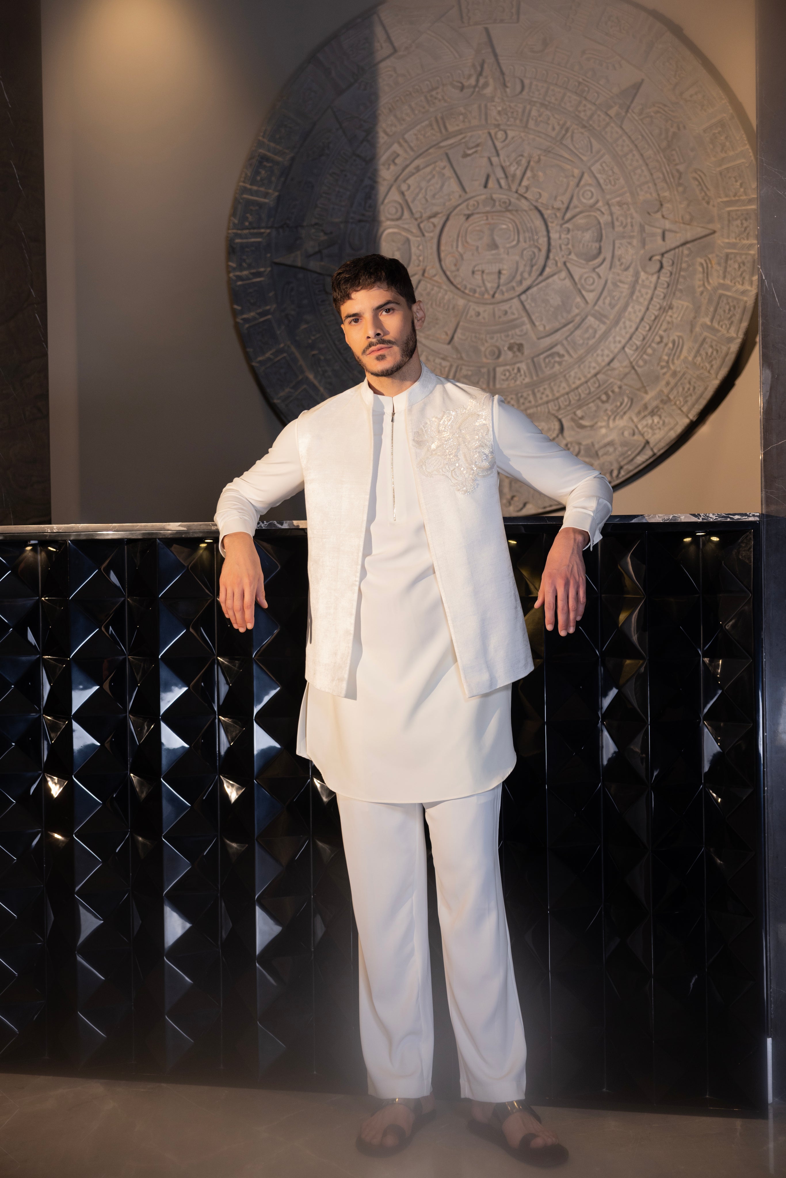 Ivroy waistcoat with a monotone hand-embroidered motif paired with a matching kurta and aligadhi set.