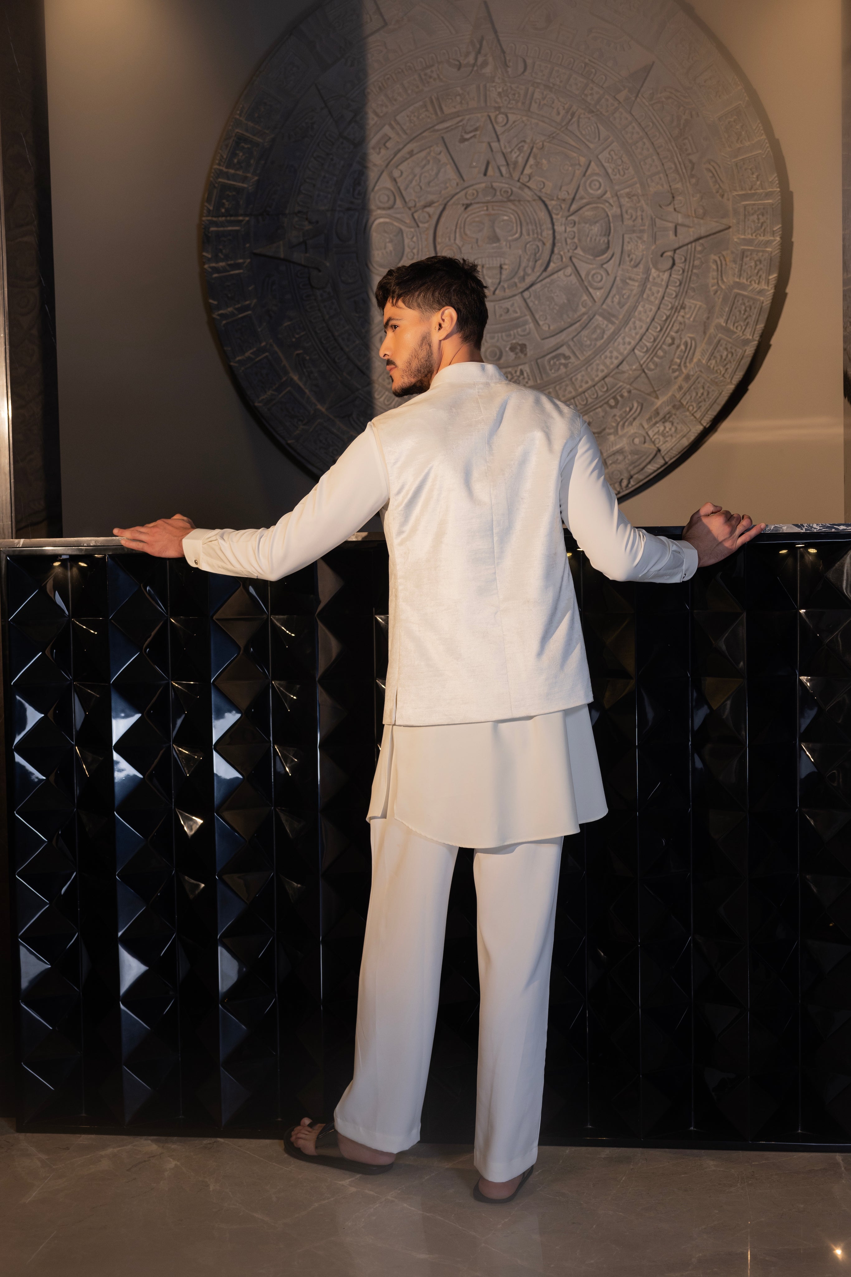 Ivroy waistcoat with a monotone hand-embroidered motif paired with a matching kurta and aligadhi set.