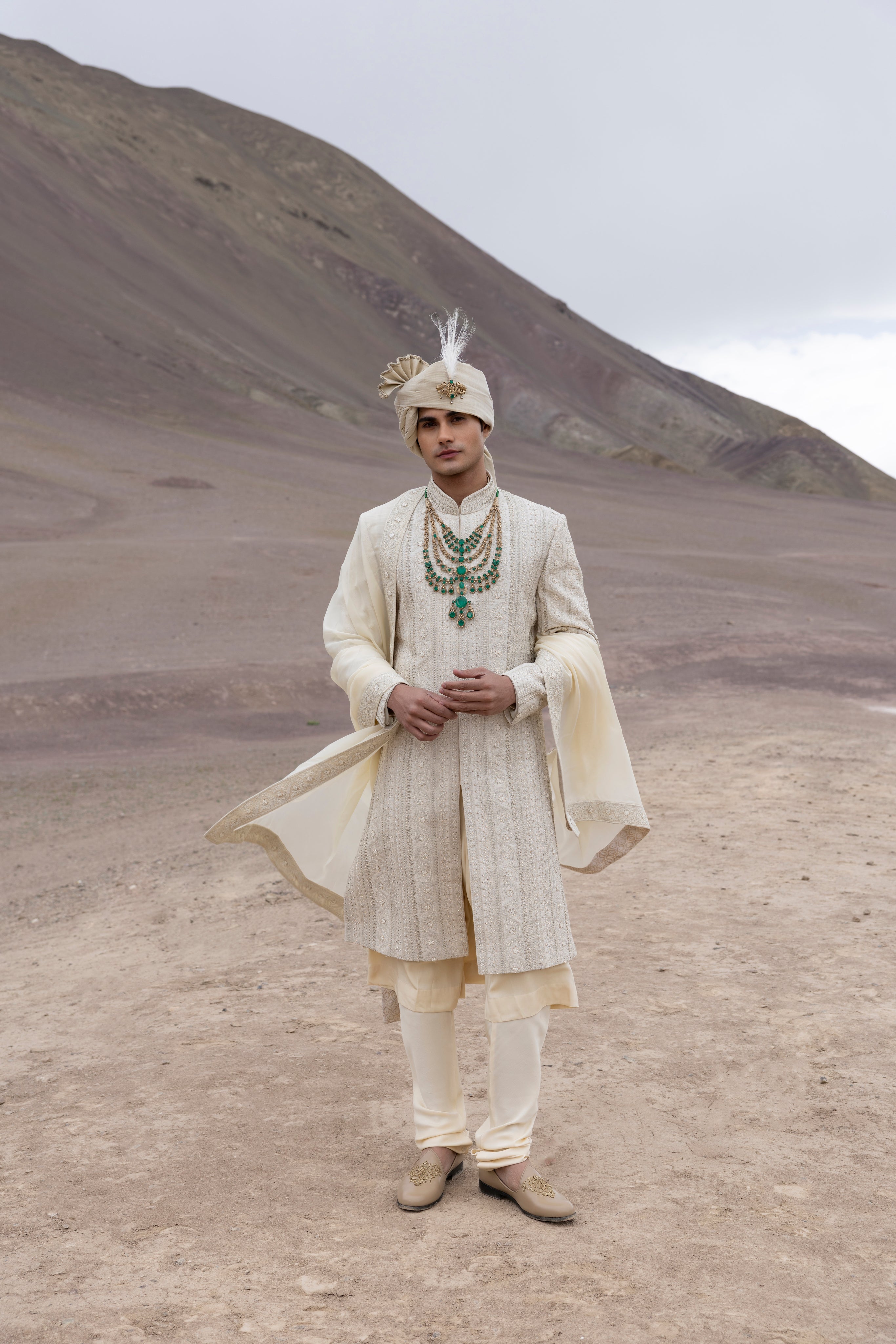 Light Gold raw silk sherwani with intricate hand-embroidery paired with a modal kurta pyjama & an organza stole.