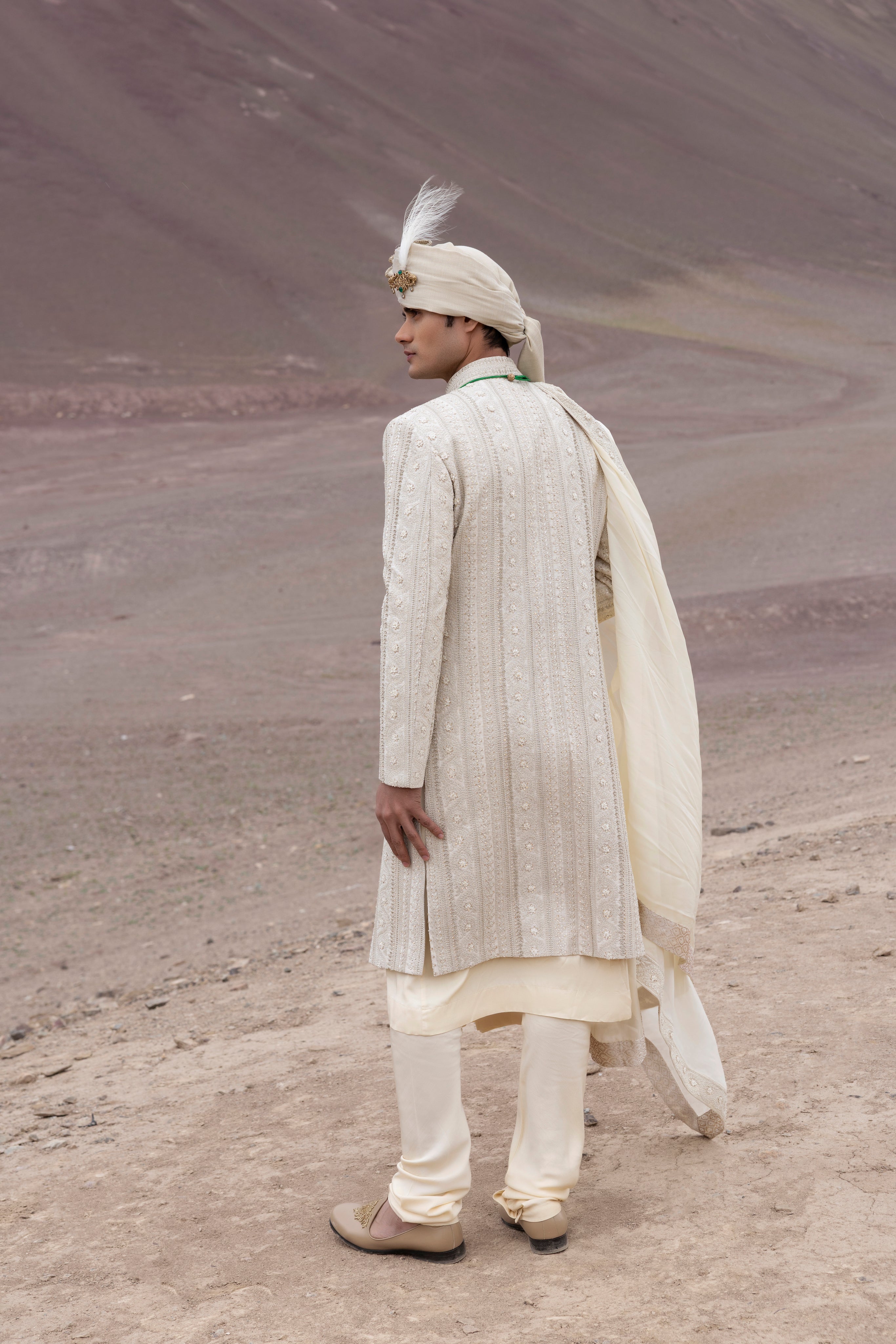 Light Gold raw silk sherwani with intricate hand-embroidery paired with a modal kurta pyjama & an organza stole.