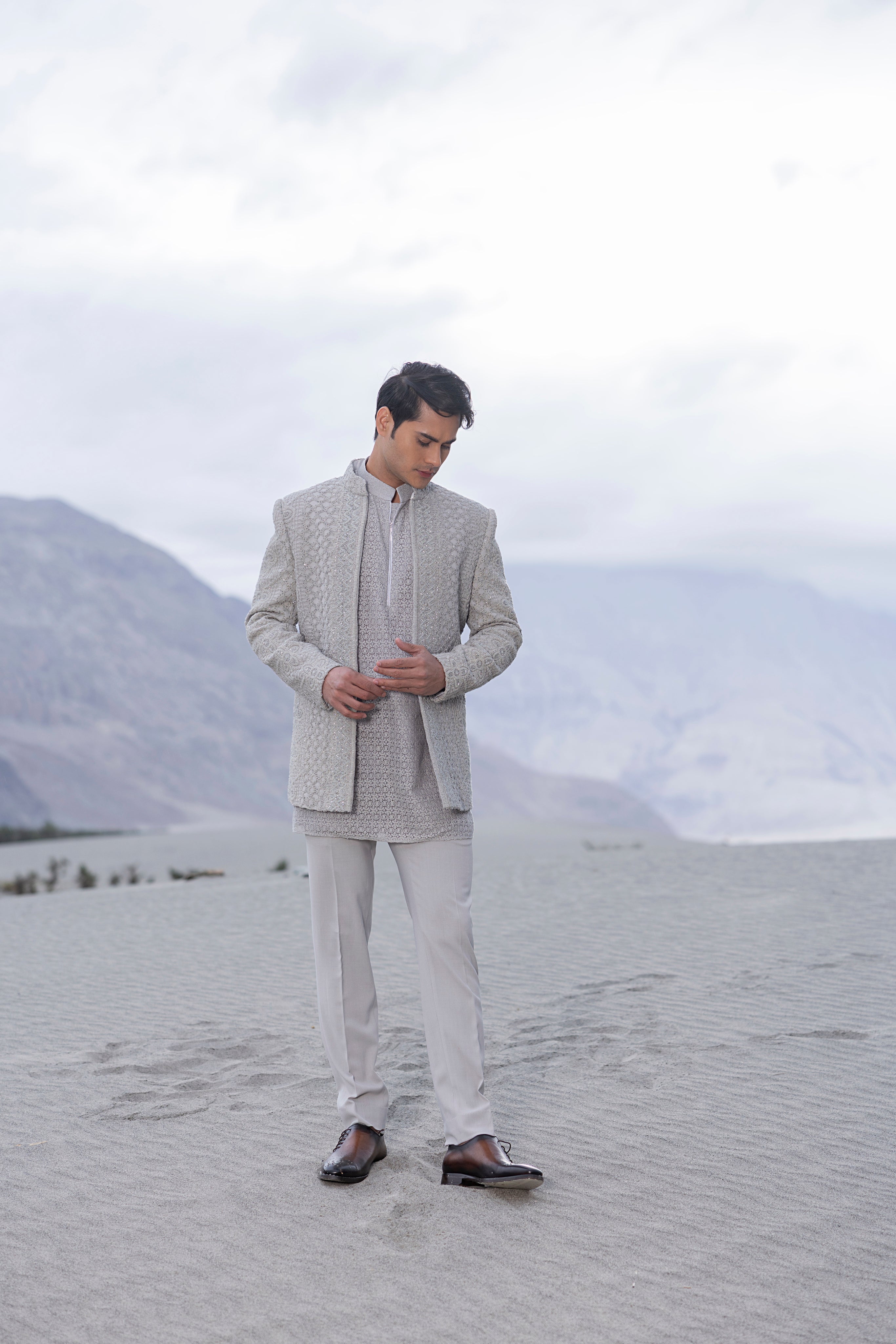 Light Grey crochet hand-embroidered open indowestern jacket paired with a crochet kurta with zip detailing  and a pant.