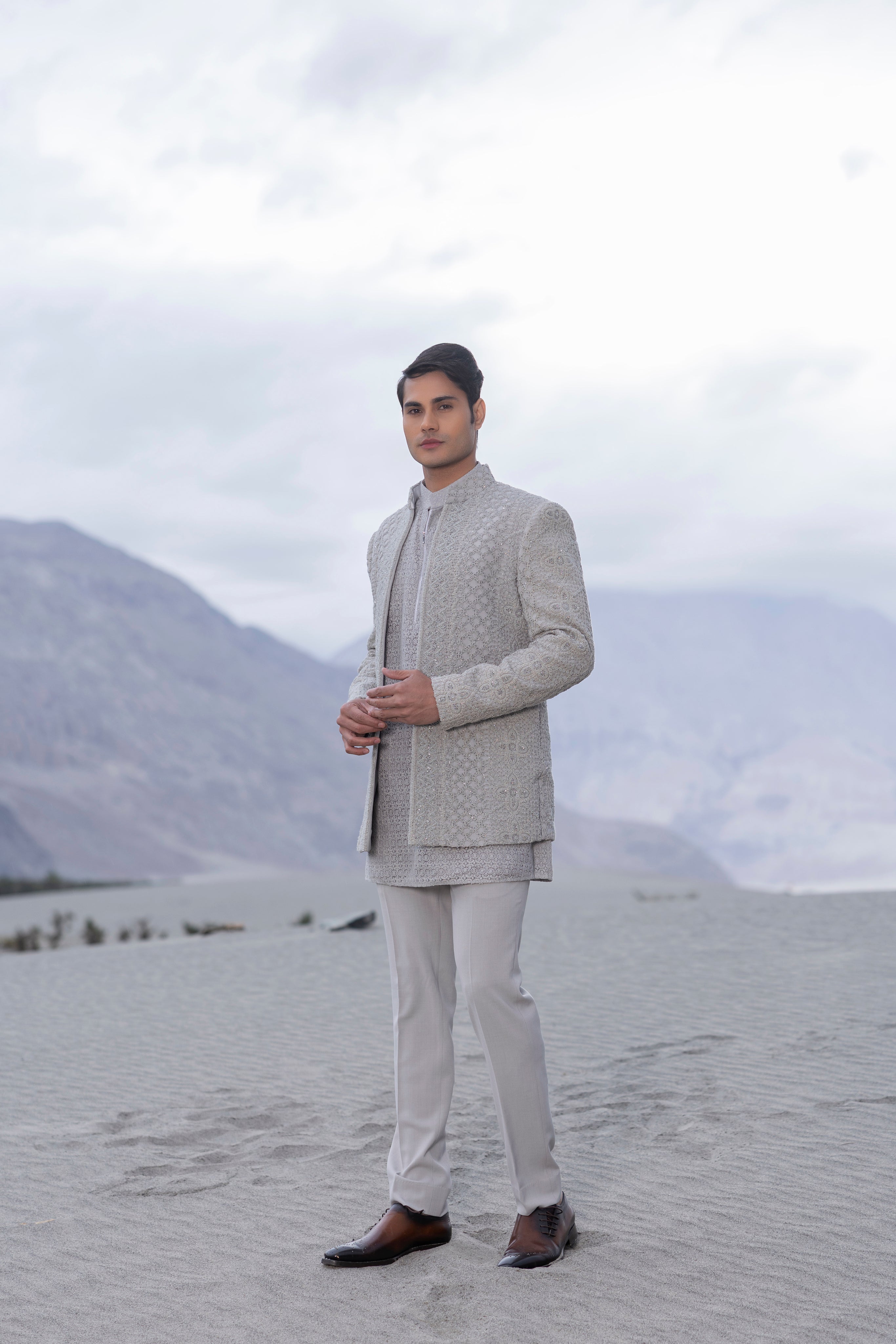 Light Grey crochet hand-embroidered open indowestern jacket paired with a crochet kurta with zip detailing  and a pant.