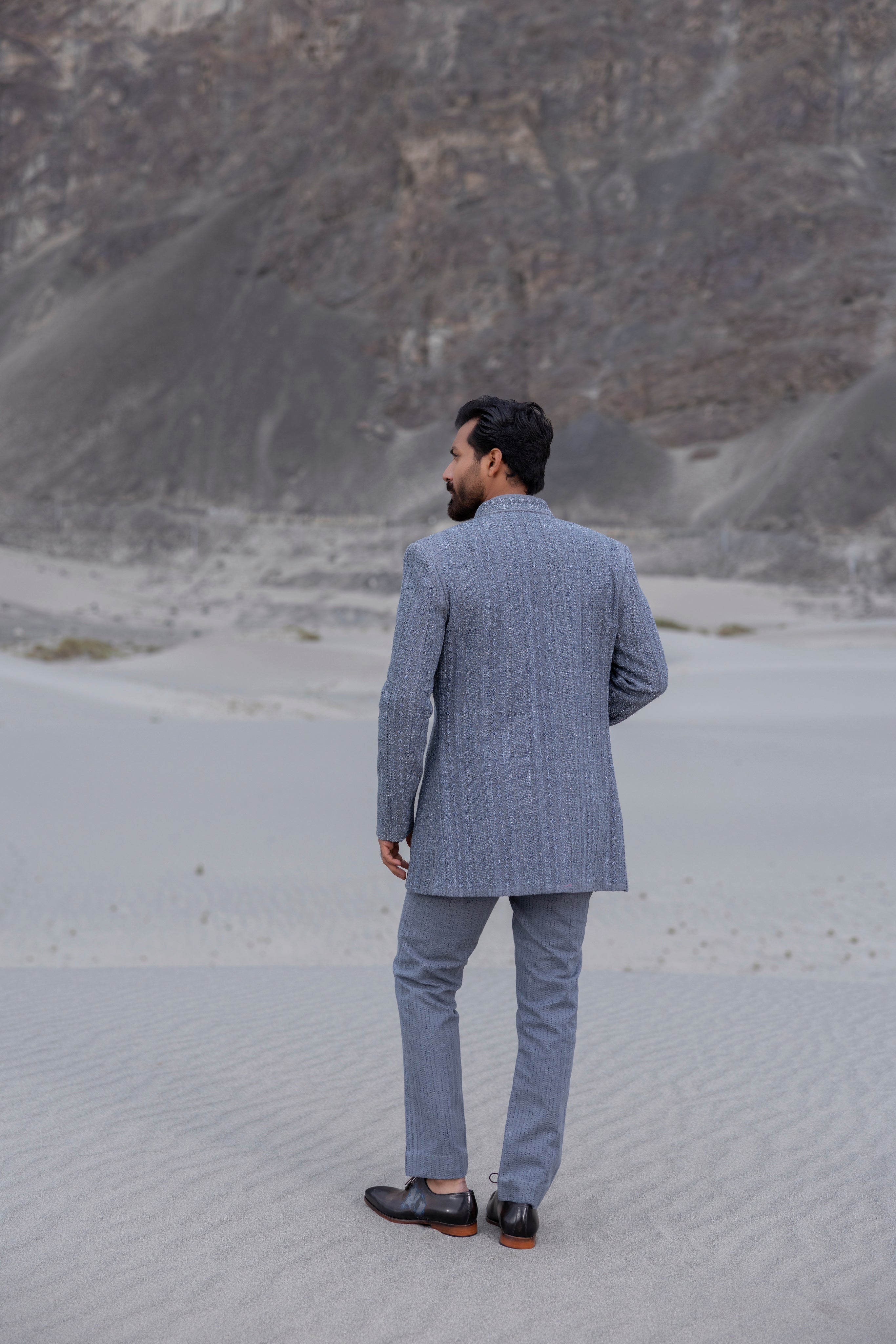 Grey front open indowestern jacket with hand-embroidered crochet detailing  paired with matching crochet pants and a waistcoat.