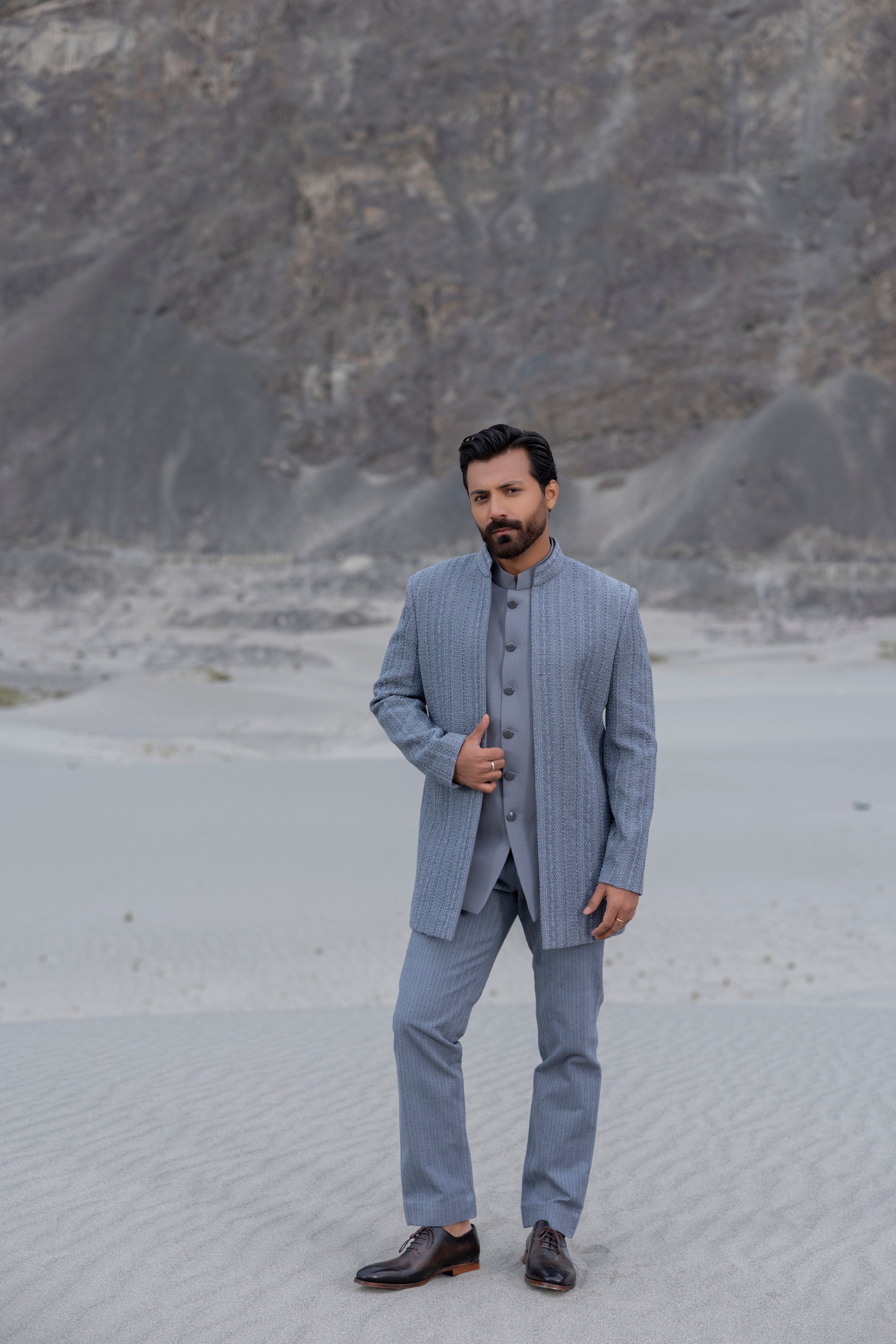 Grey front open indowestern jacket with hand-embroidered crochet detailing  paired with matching crochet pants and a waistcoat.