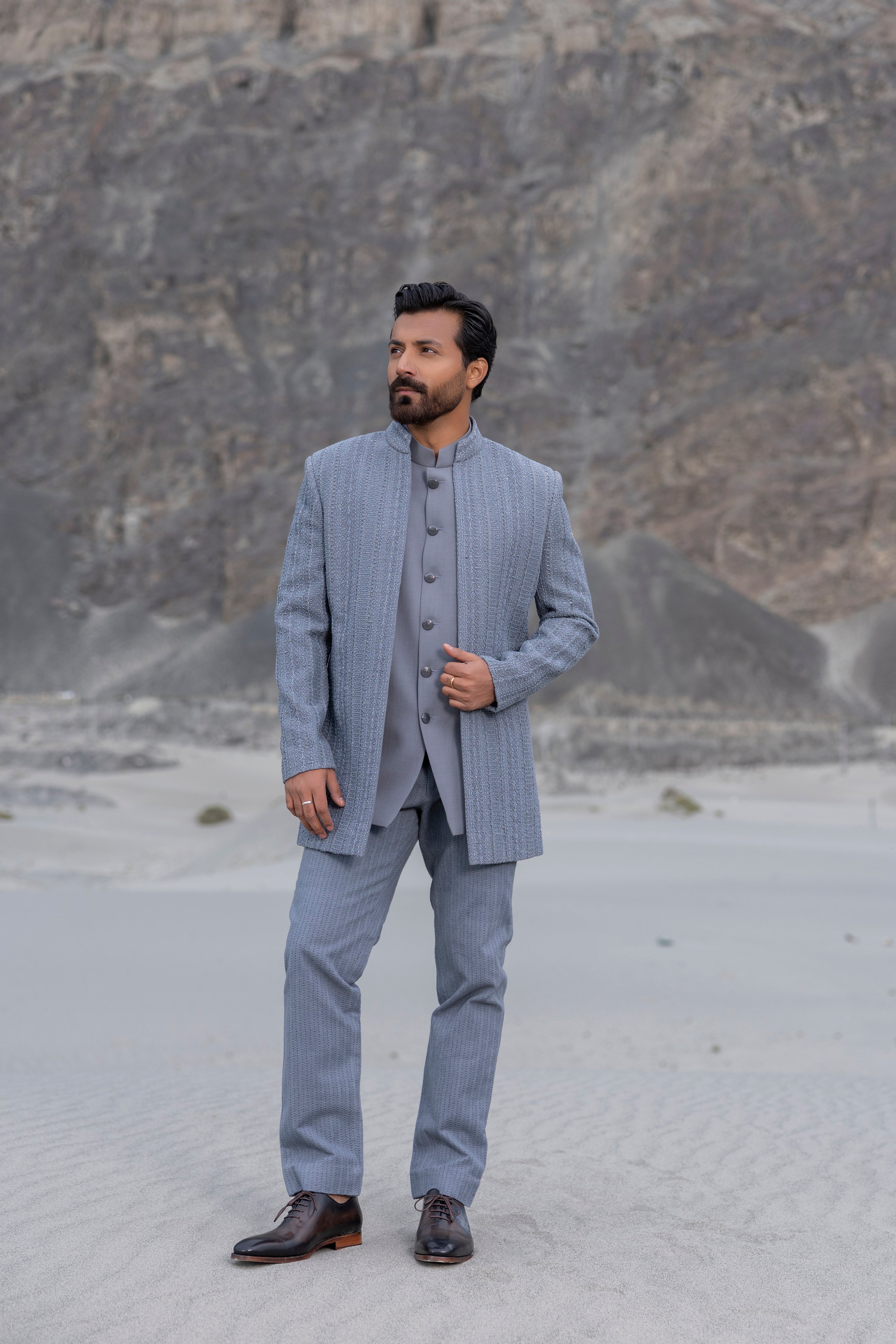 Grey front open indowestern jacket with hand-embroidered crochet detailing  paired with matching crochet pants and a waistcoat.