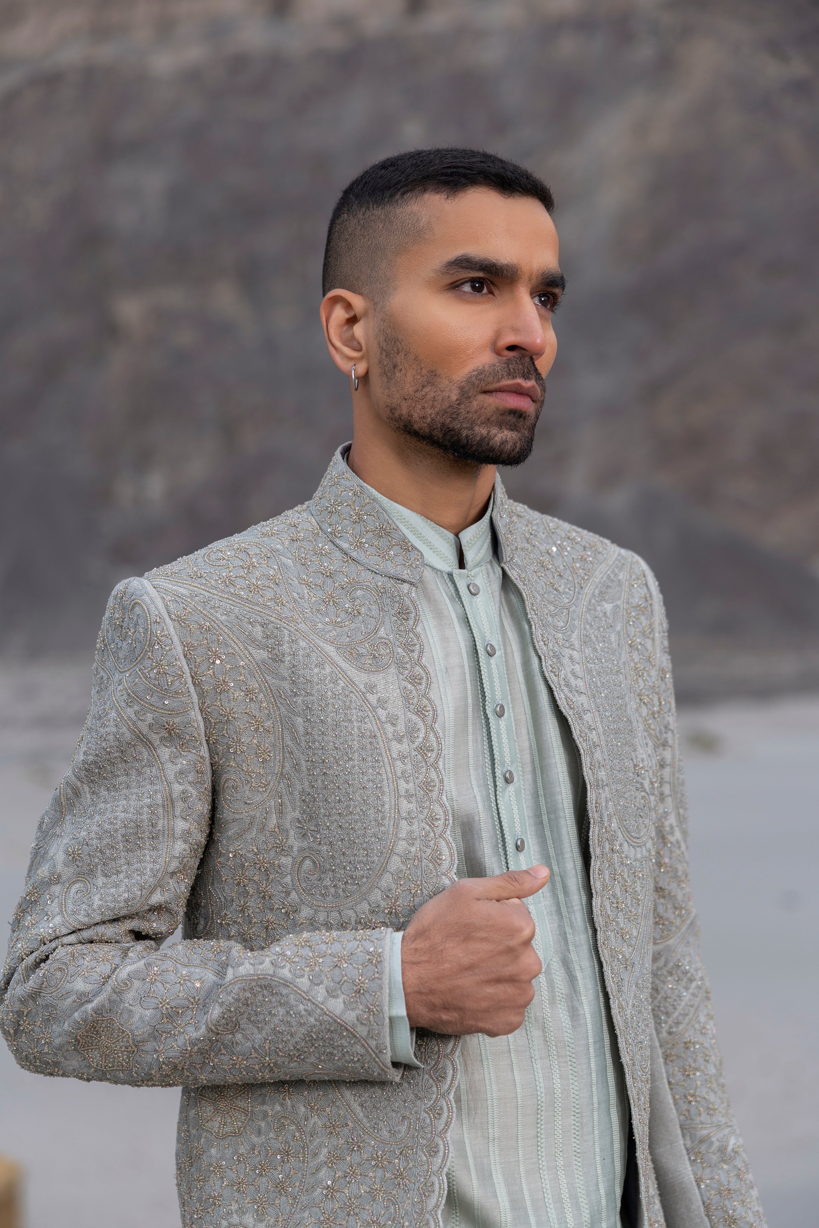 Navy Blue front open short indowestern jacket with monotone hand-embroidery paired with a crochet kurtawith zipper detailing  and a pant. (Copy)