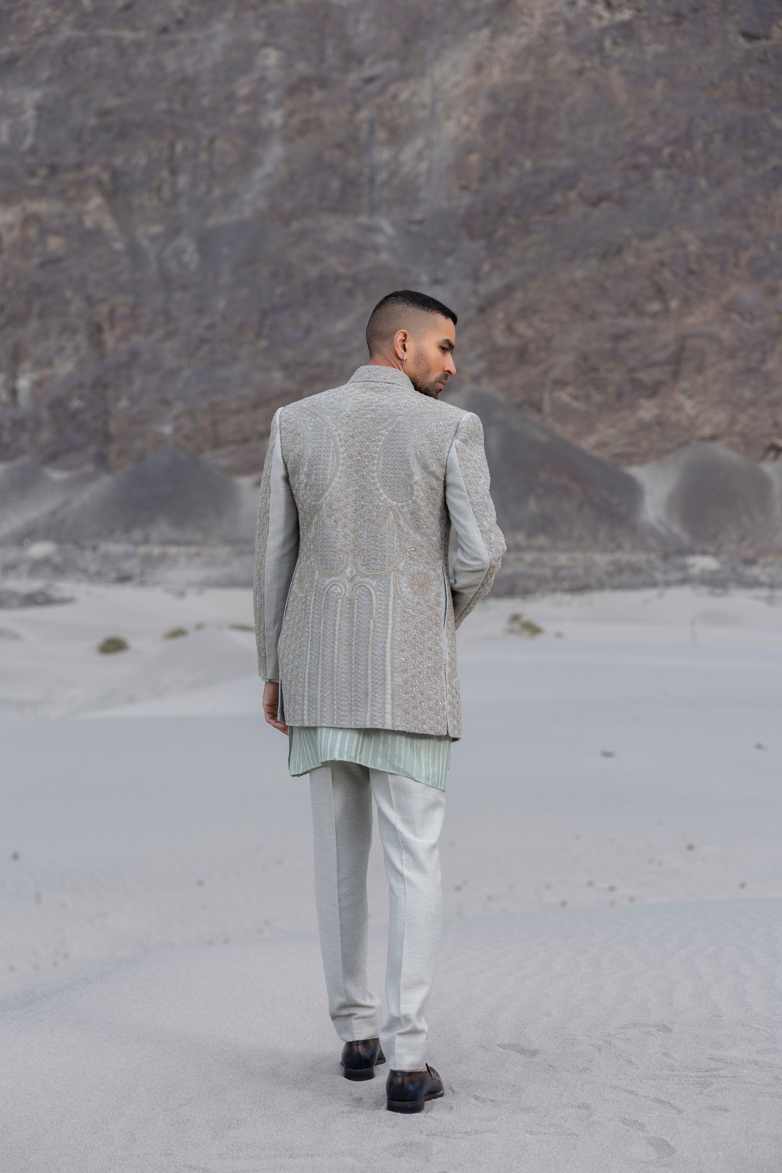 Navy Blue front open short indowestern jacket with monotone hand-embroidery paired with a crochet kurtawith zipper detailing  and a pant. (Copy)