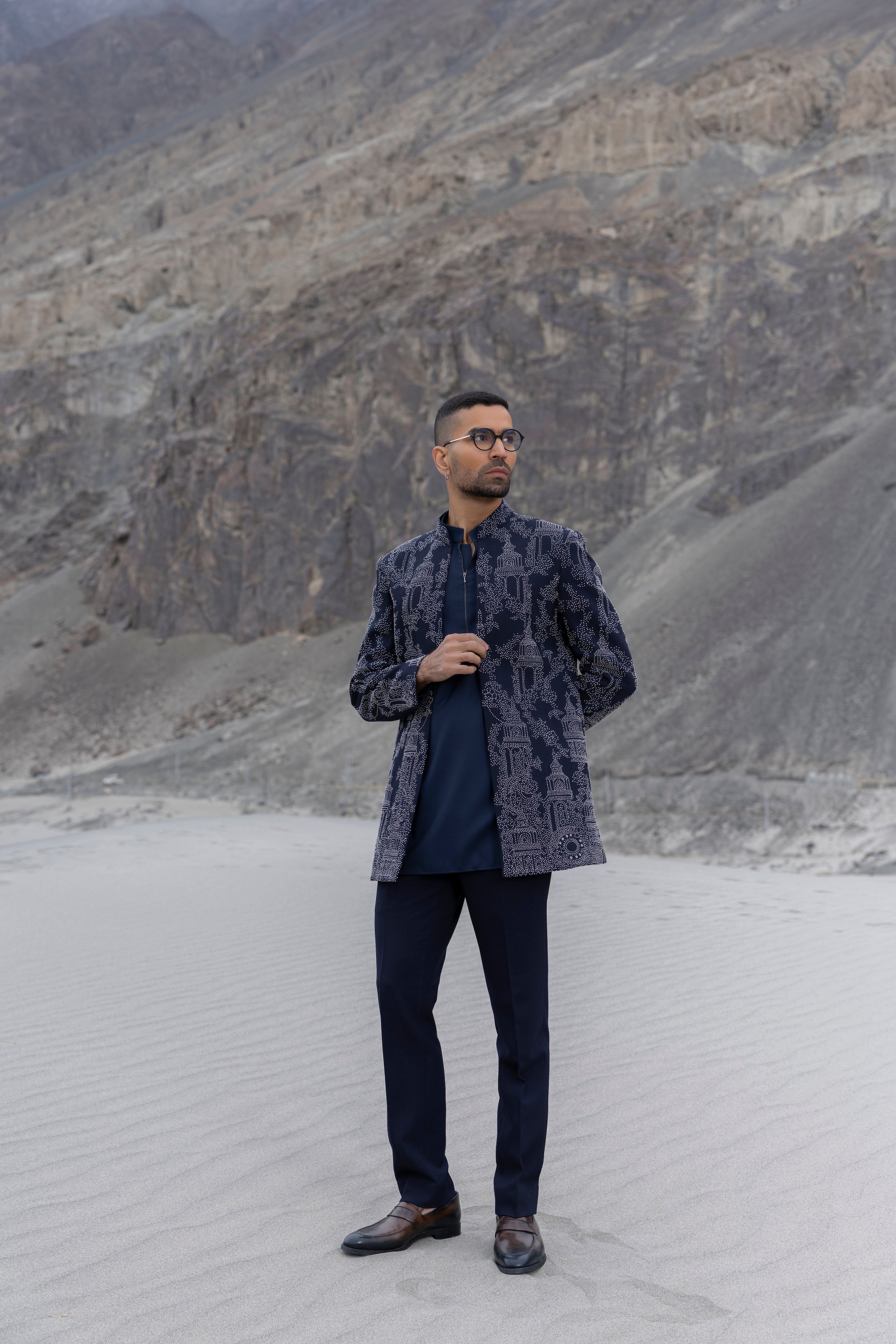 Navy Blue open indowestern jacket with hand-embroidered motifs paired with a zippered short kurta and pants.