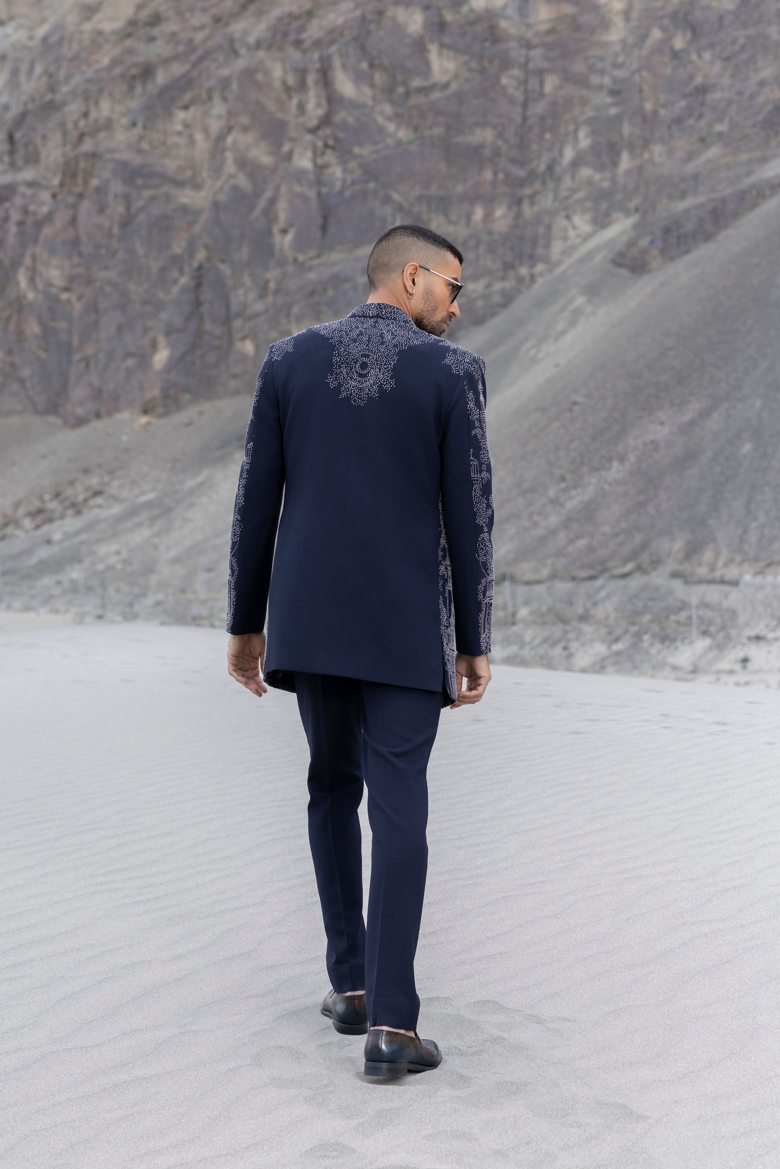 Navy Blue open indowestern jacket with hand-embroidered motifs paired with a zippered short kurta and pants.