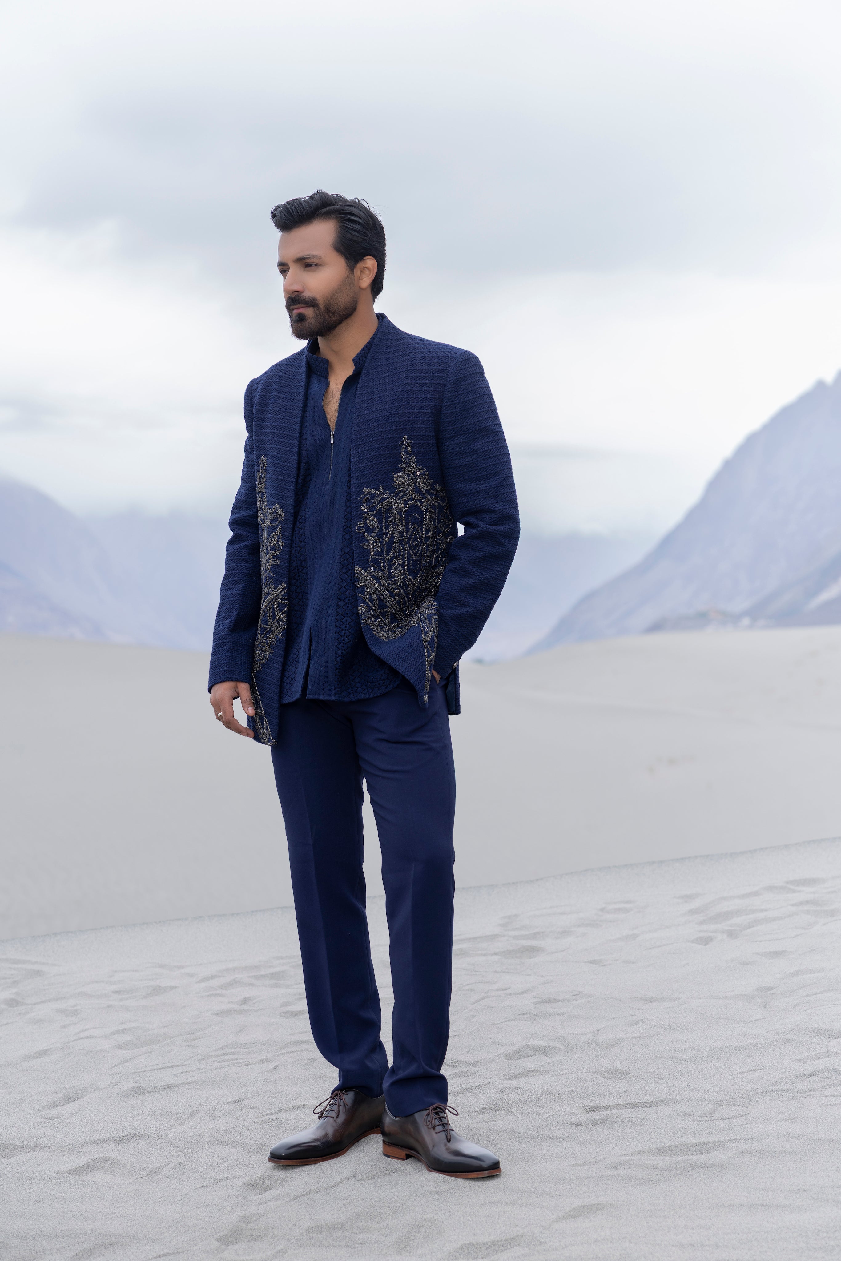 Navay Blue crochet front open indowestern jacket with contrast hand-embroidery  paired with matching crochet short kurta and a pant.