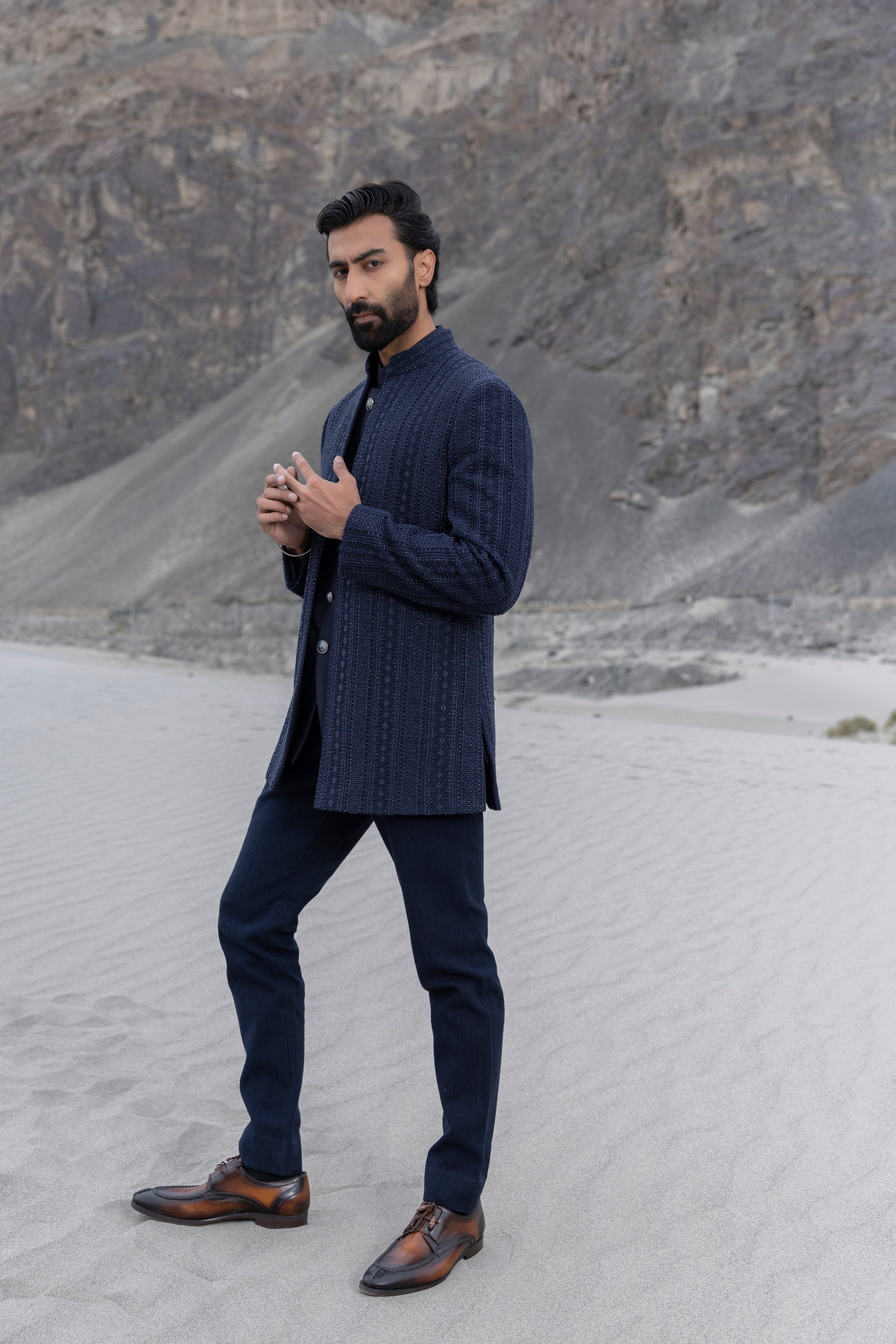 Navy Blue crochet hand-embroidered open indowestern jacket paired with matching crochet pants and a waistcoat.