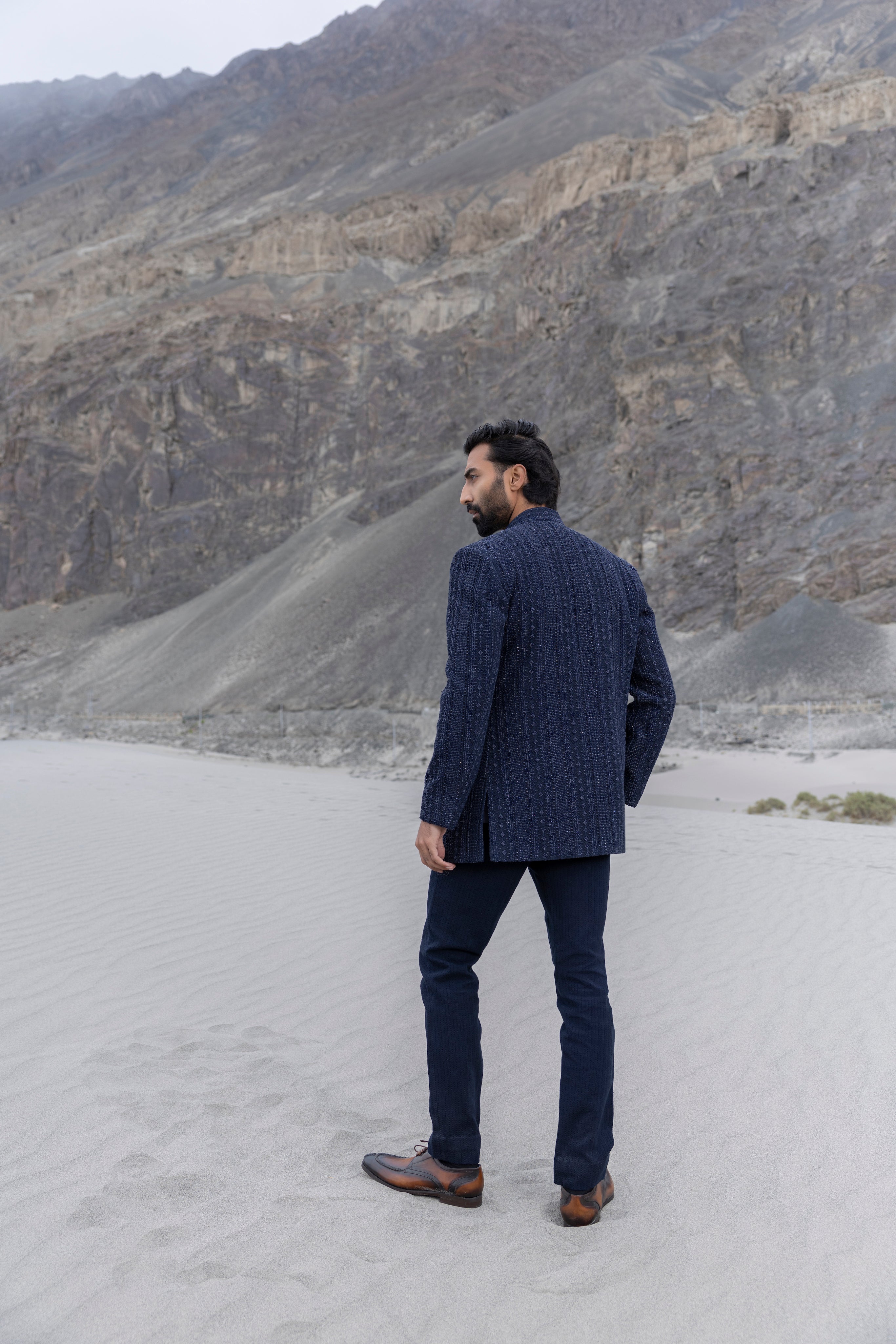 Navy Blue crochet hand-embroidered open indowestern jacket paired with matching crochet pants and a waistcoat.