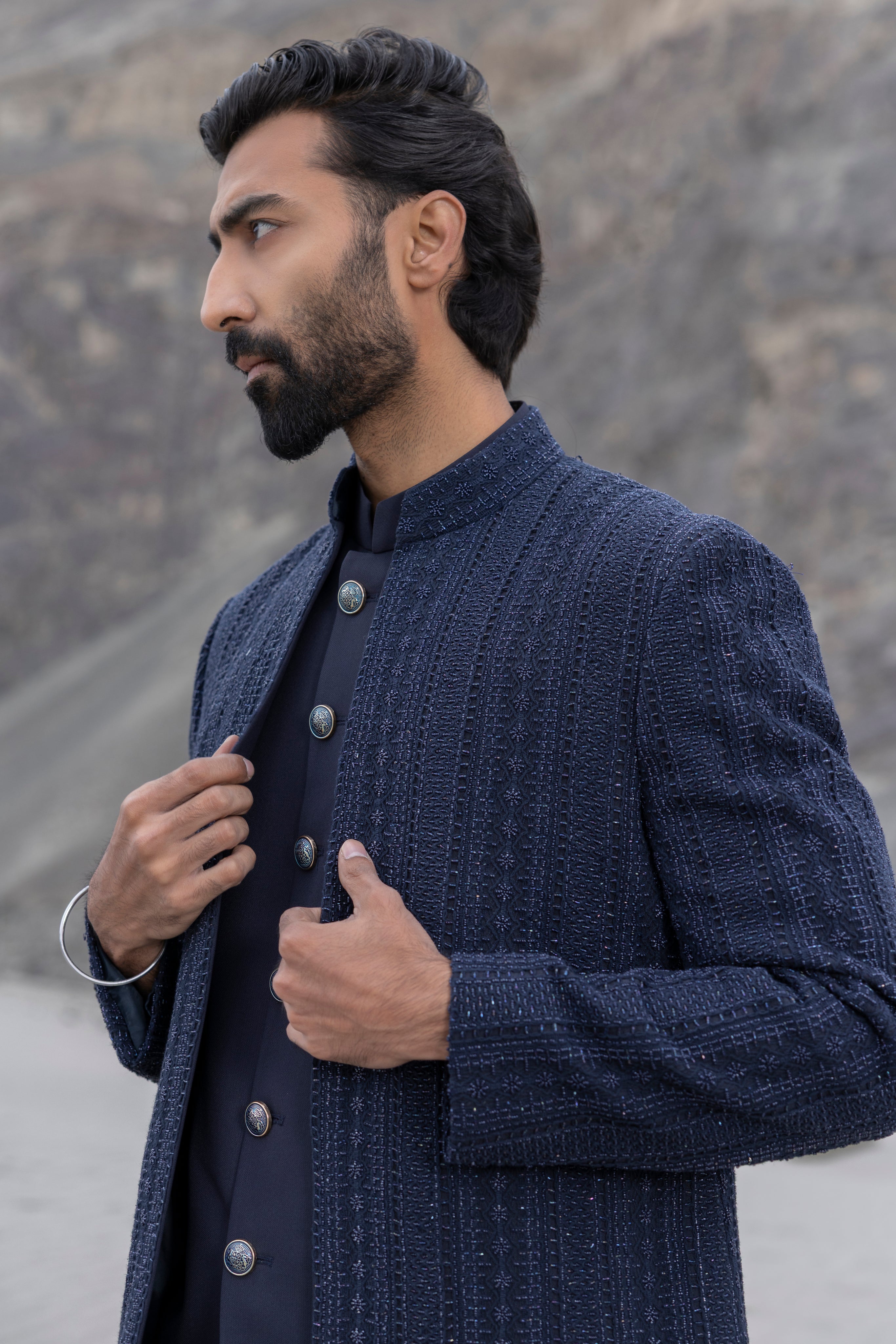 Navy Blue crochet hand-embroidered open indowestern jacket paired with matching crochet pants and a waistcoat.
