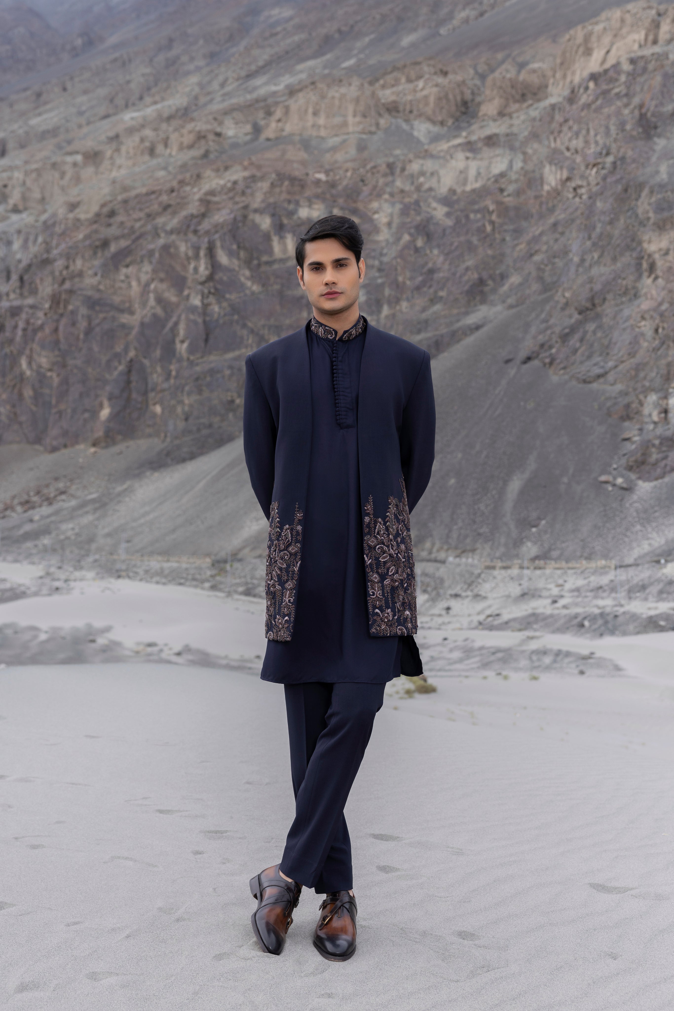 Navy Blue front open long indowestern jacket with floral hand-embroidery paired with a  kurta with  embroidered collar and pants.
