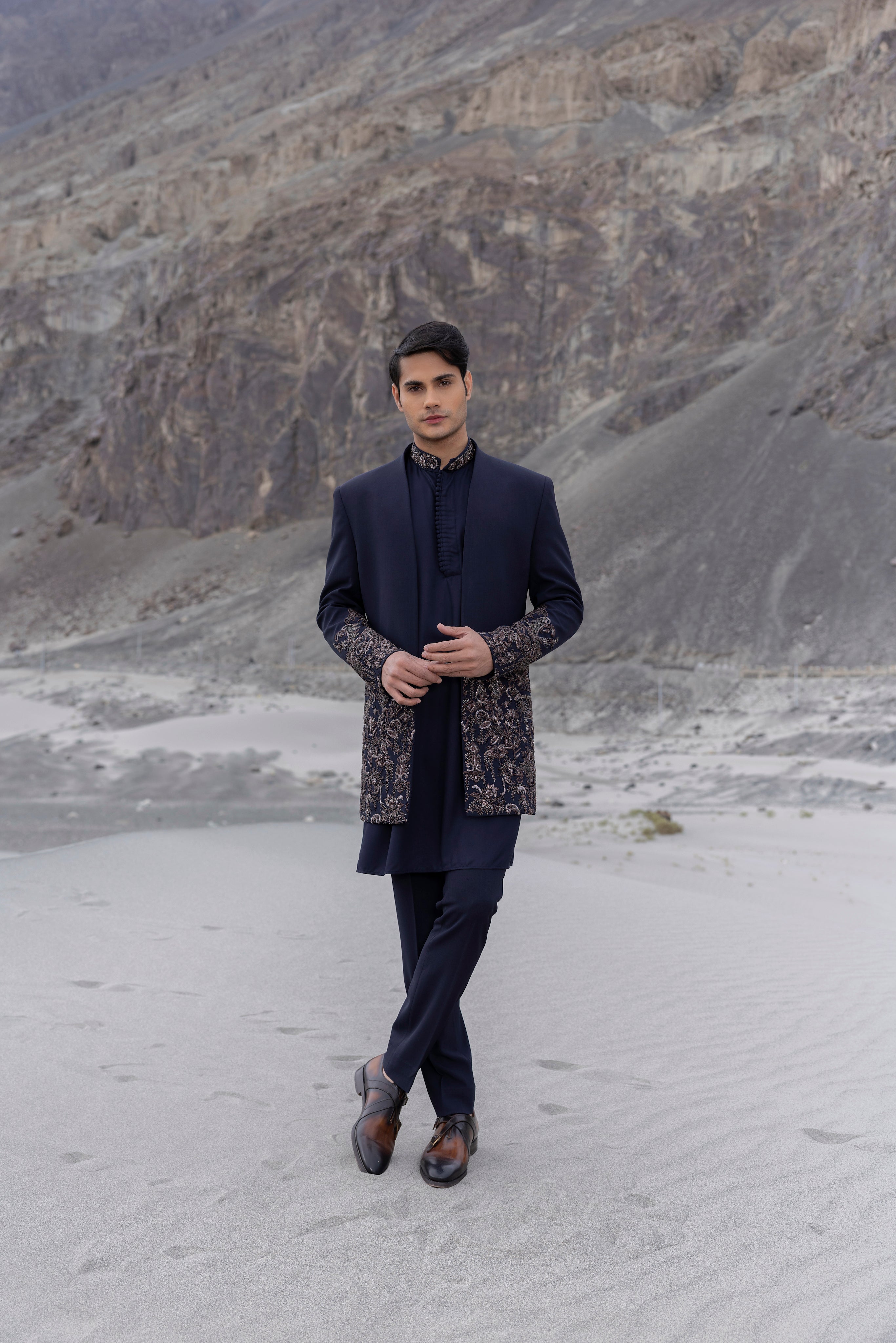 Navy Blue front open long indowestern jacket with floral hand-embroidery paired with a  kurta with  embroidered collar and pants.
