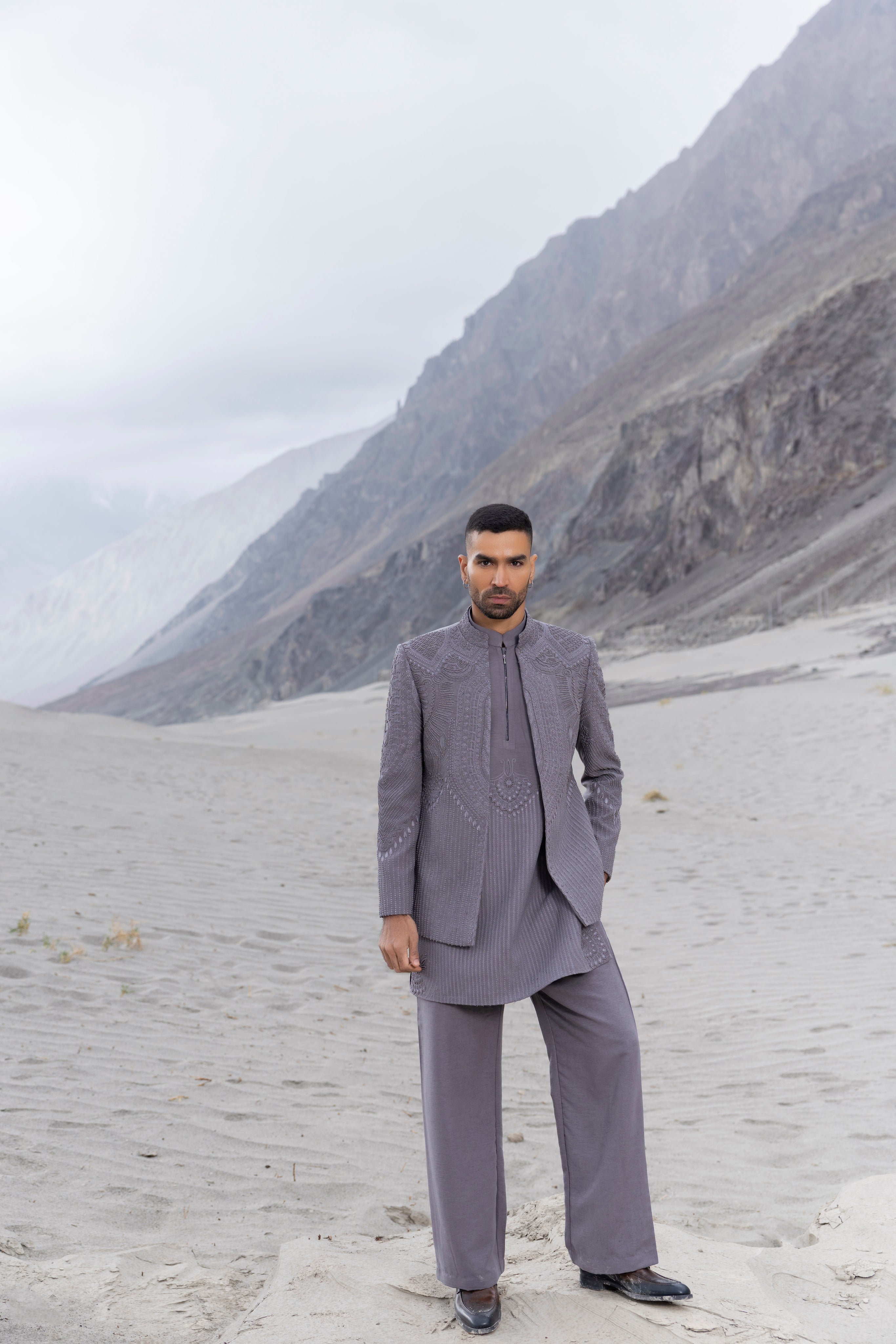 Grey front open hand-embroidered indowestern jacket paired with an hand-embroidered  kurta and pants.