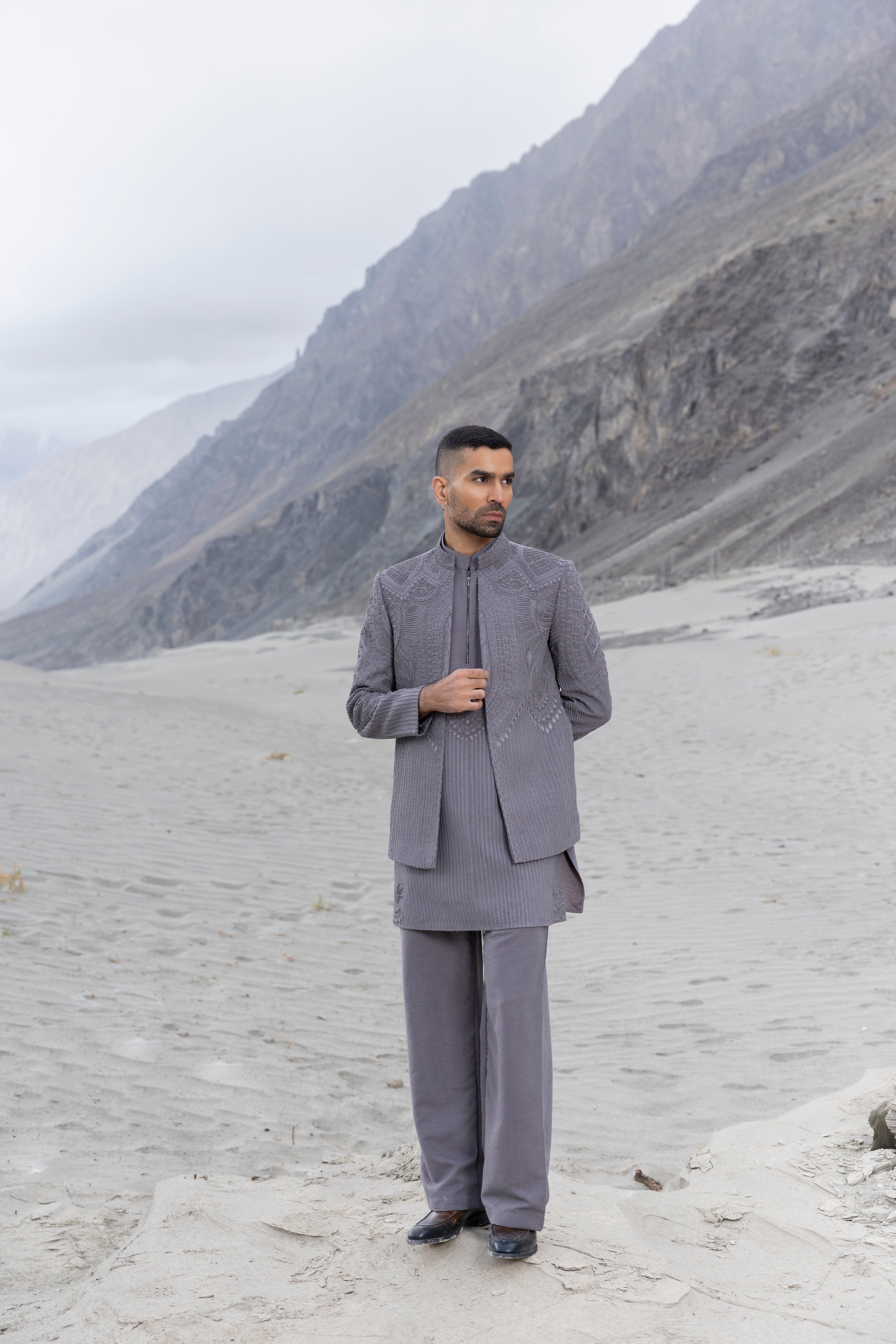 Grey front open hand-embroidered indowestern jacket paired with an hand-embroidered  kurta and pants.