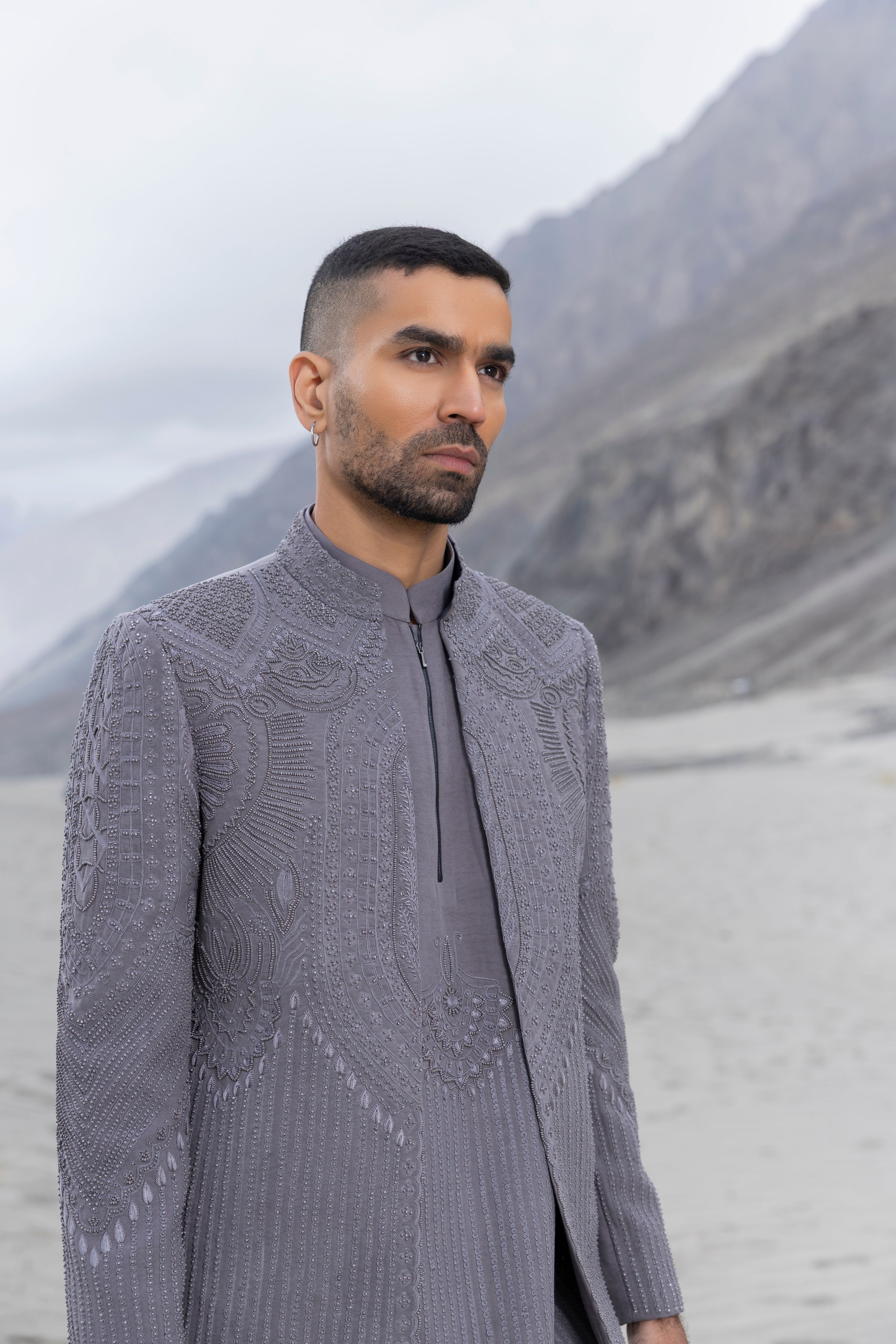 Grey front open hand-embroidered indowestern jacket paired with an hand-embroidered  kurta and pants.