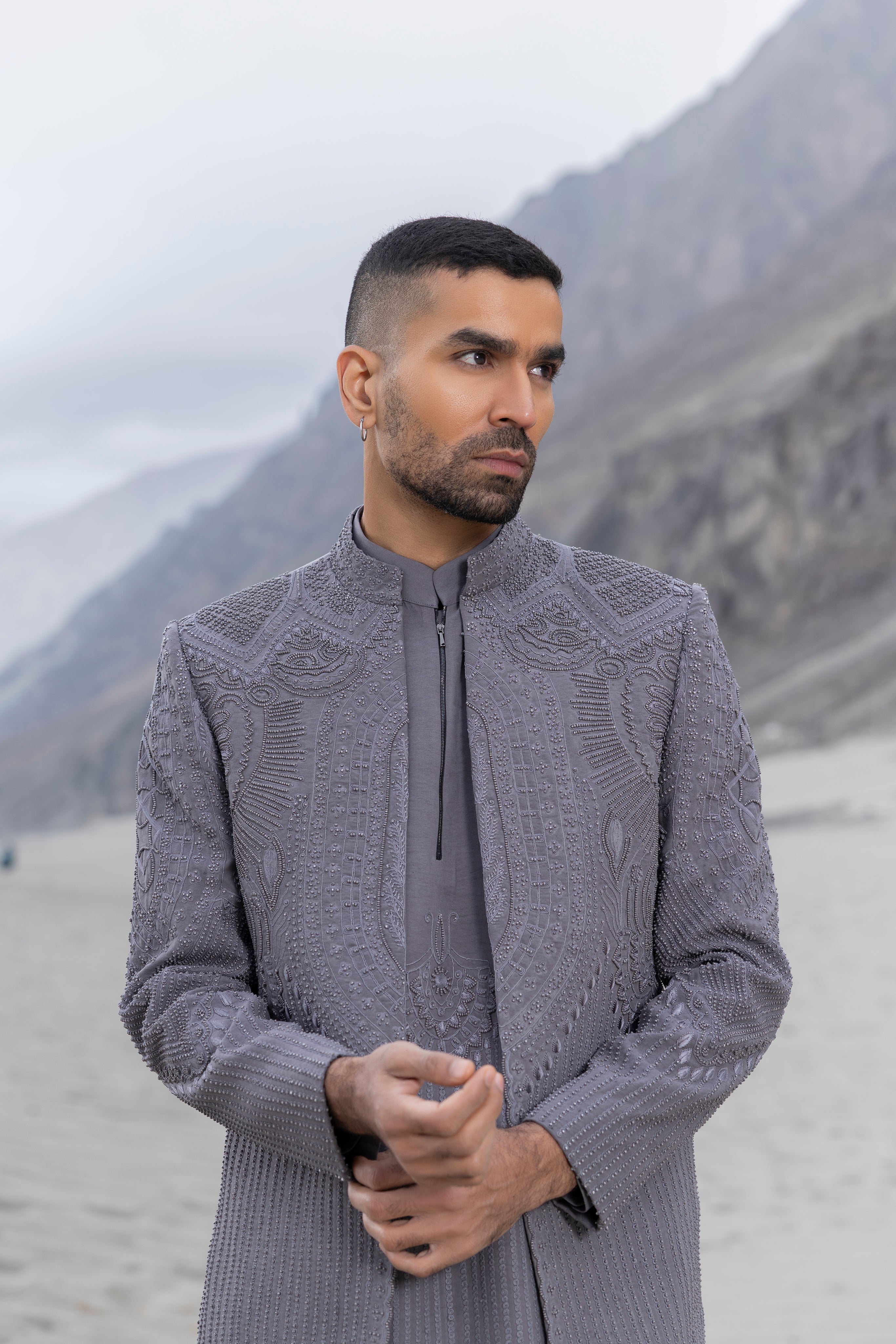 Grey front open hand-embroidered indowestern jacket paired with an hand-embroidered  kurta and pants.