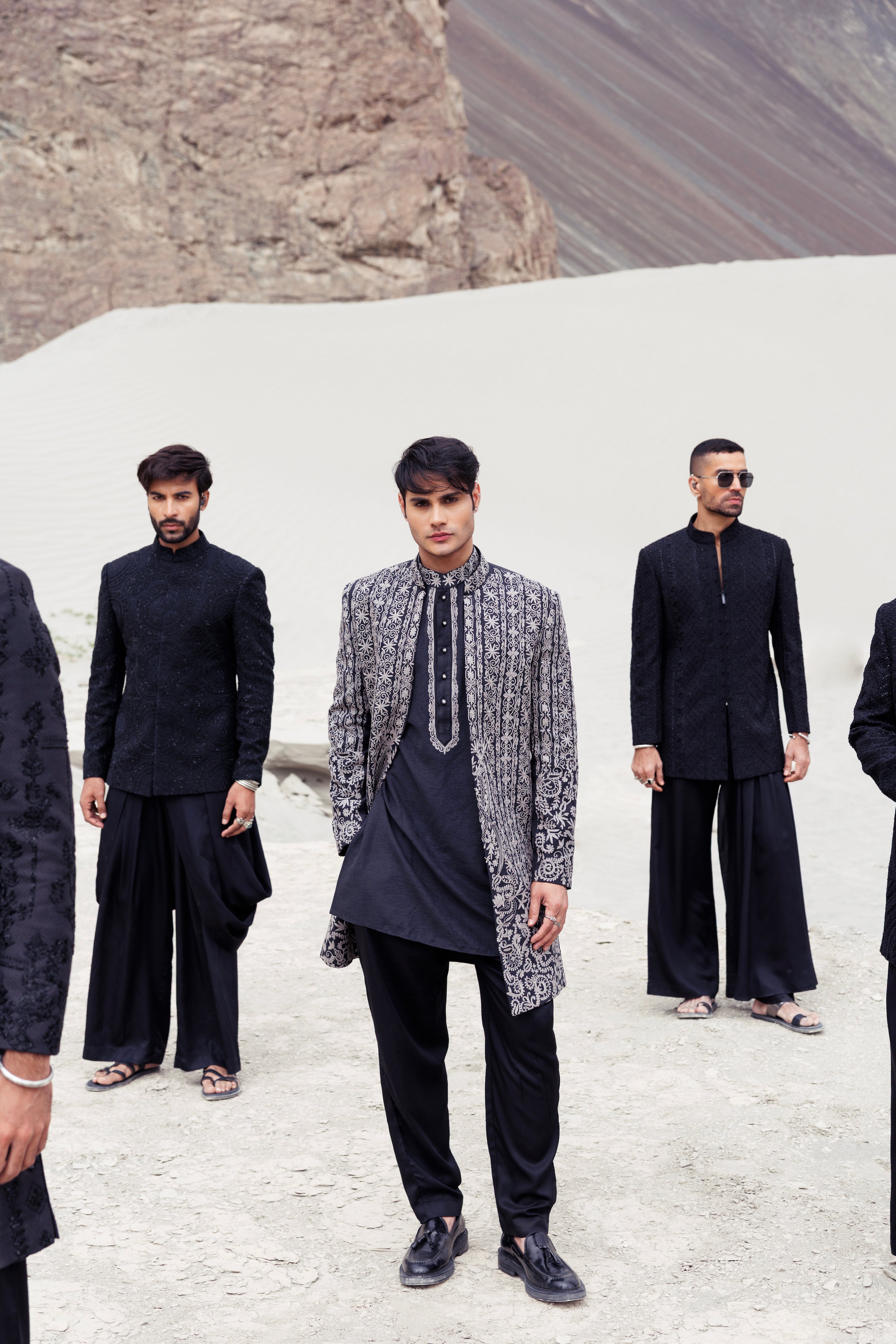 Black front open long indowestern jacket contrast hand-embroidery paired with a matching embroidered kurta and a plazo.