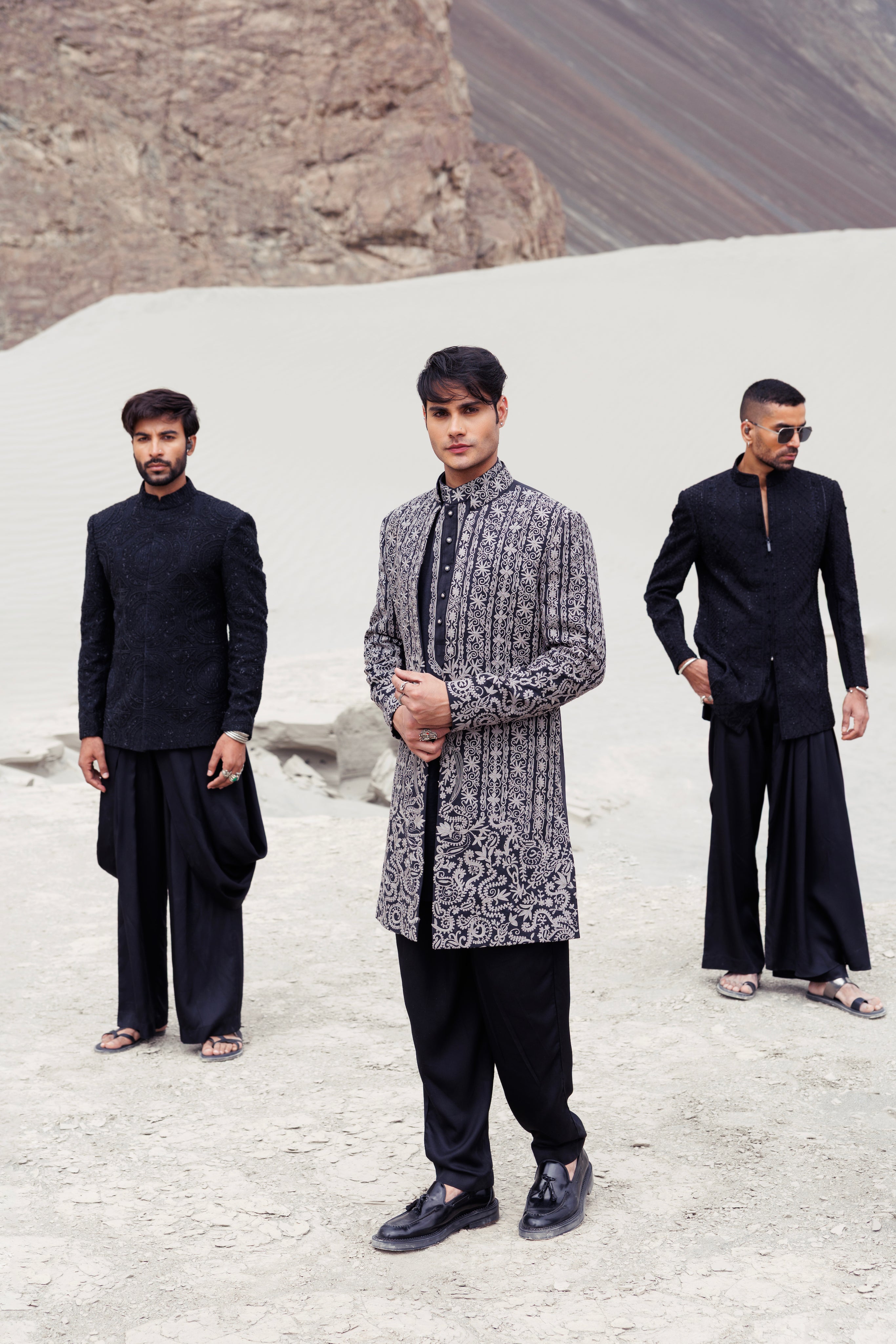 Black front open long indowestern jacket contrast hand-embroidery paired with a matching embroidered kurta and a plazo.