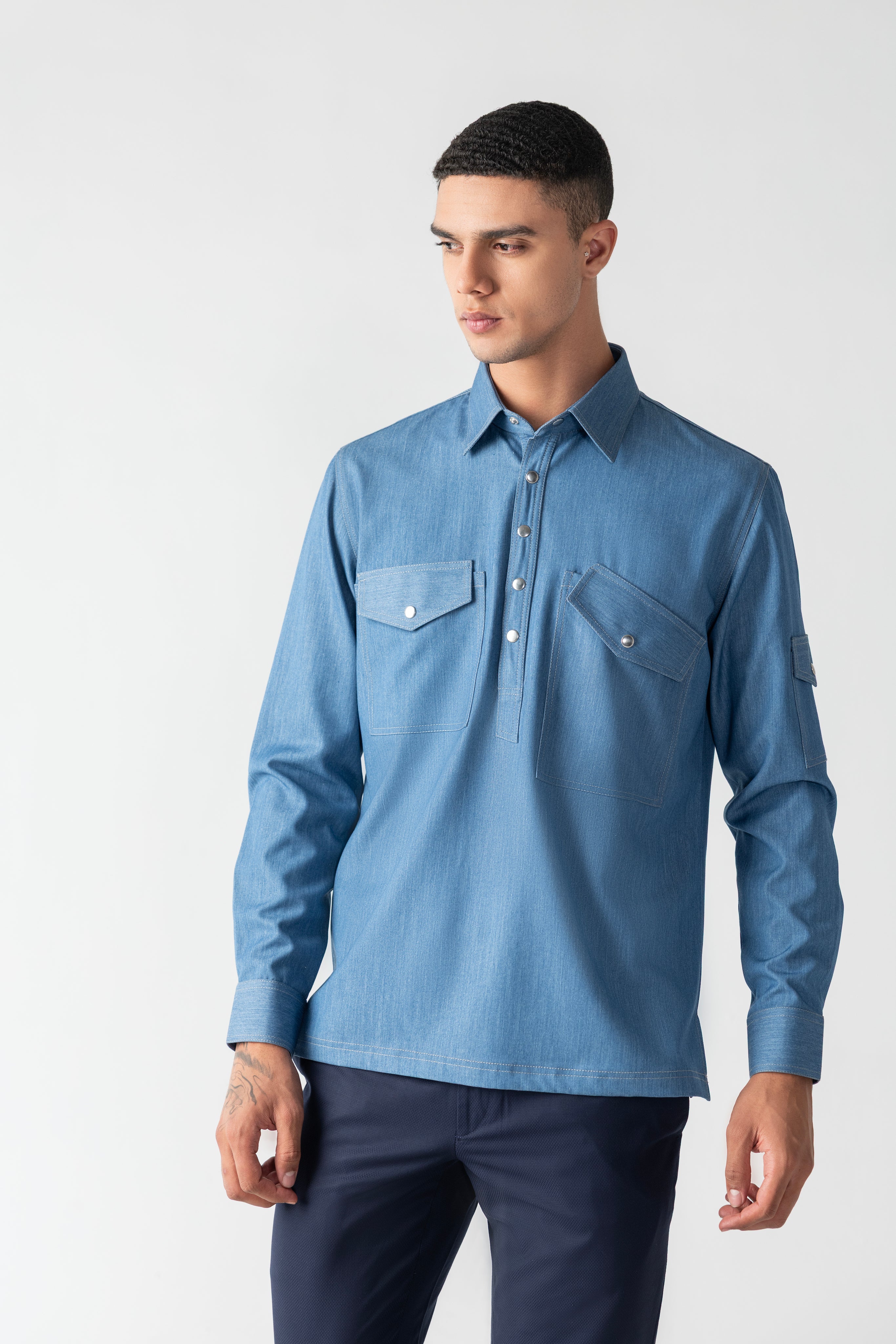 Light denim shirt with patch pocket detailing.