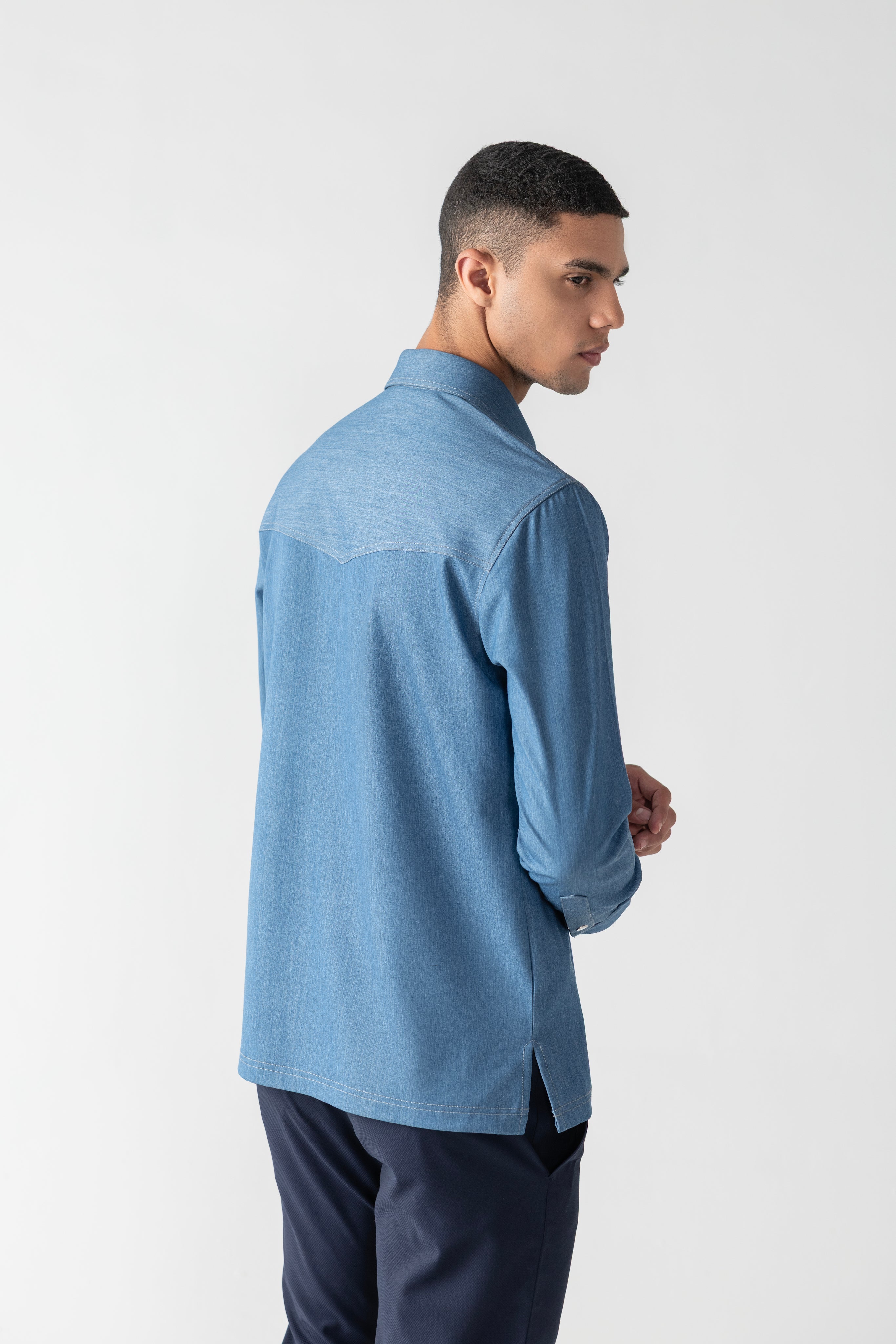 Light denim shirt with patch pocket detailing.