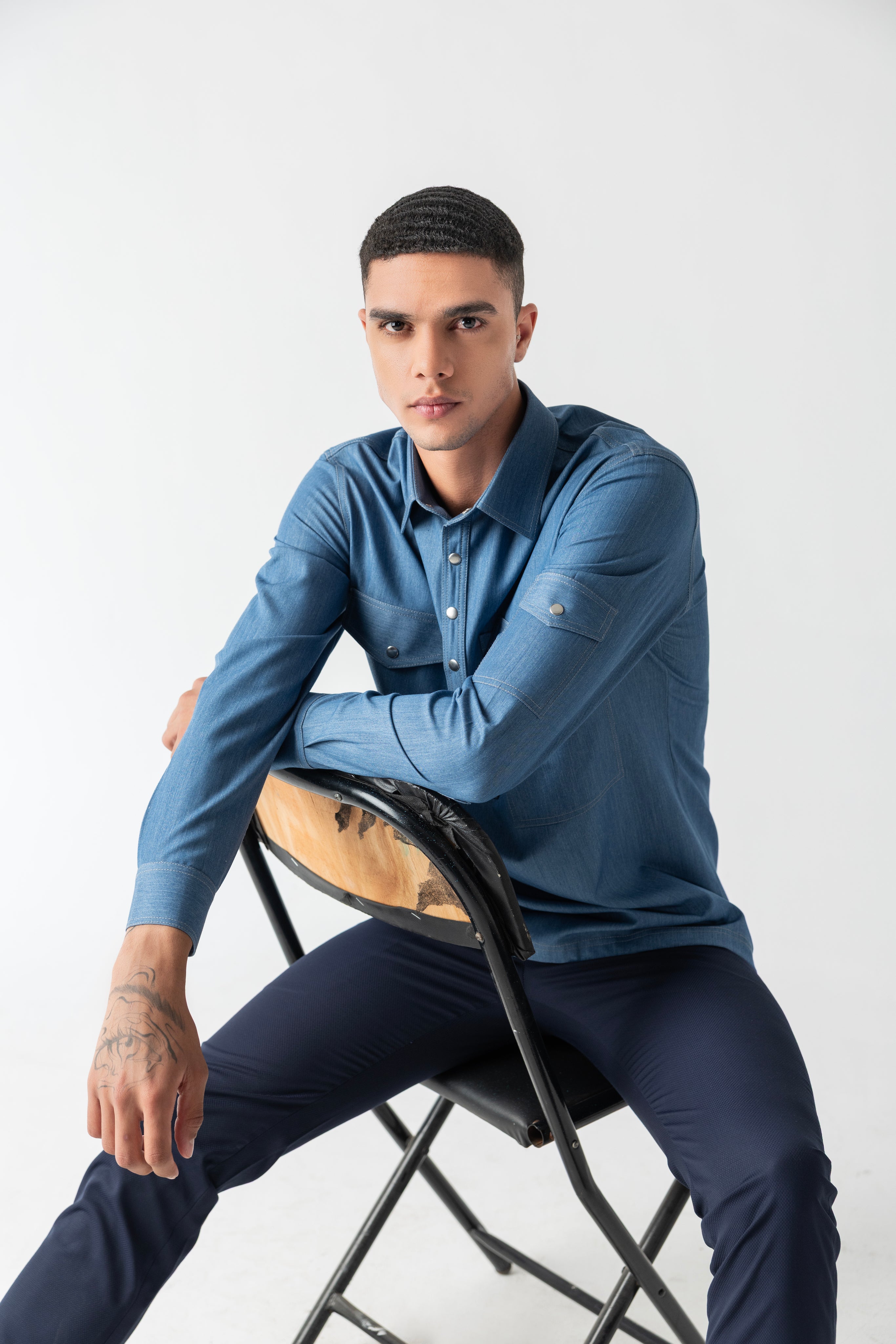 Light denim shirt with patch pocket detailing.
