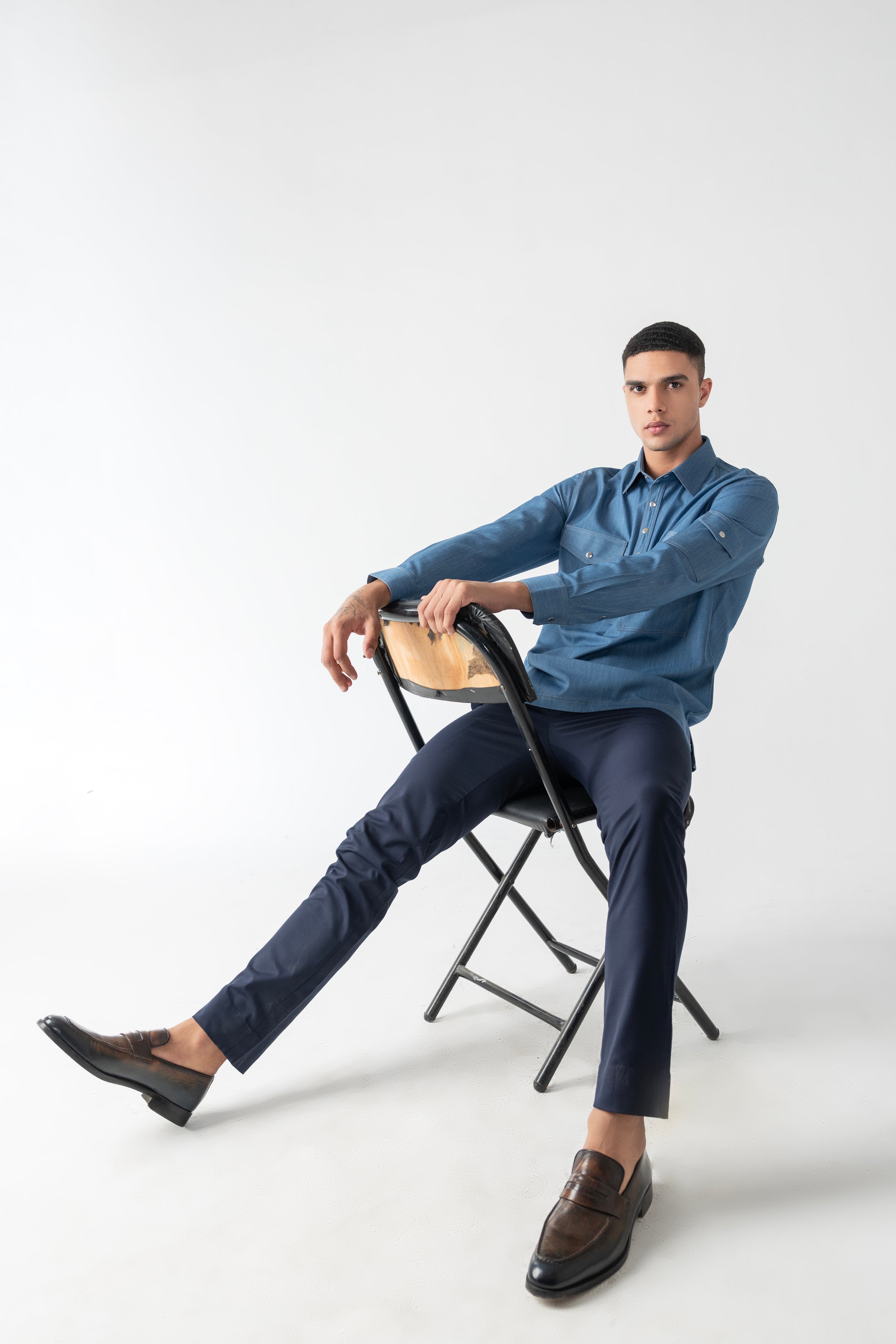 Light denim shirt with patch pocket detailing.