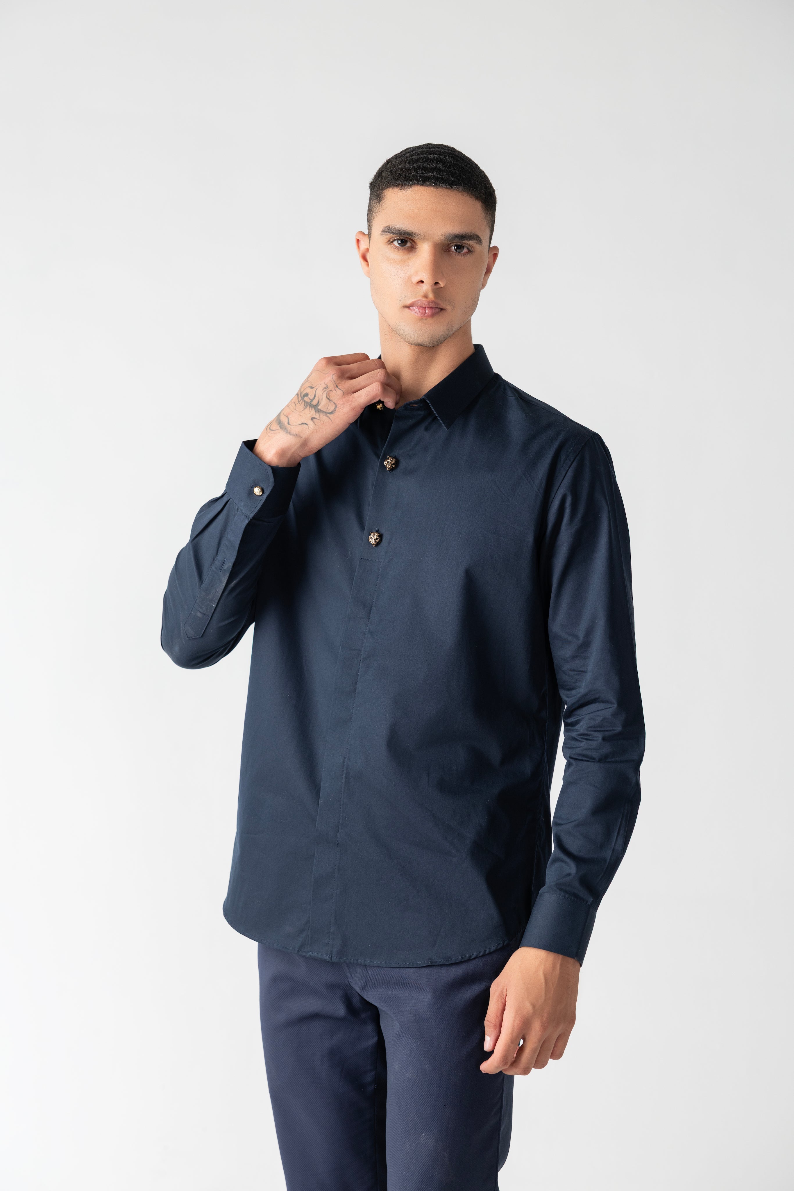 Navy blue hidden button placket shirt with leopard button detailing.