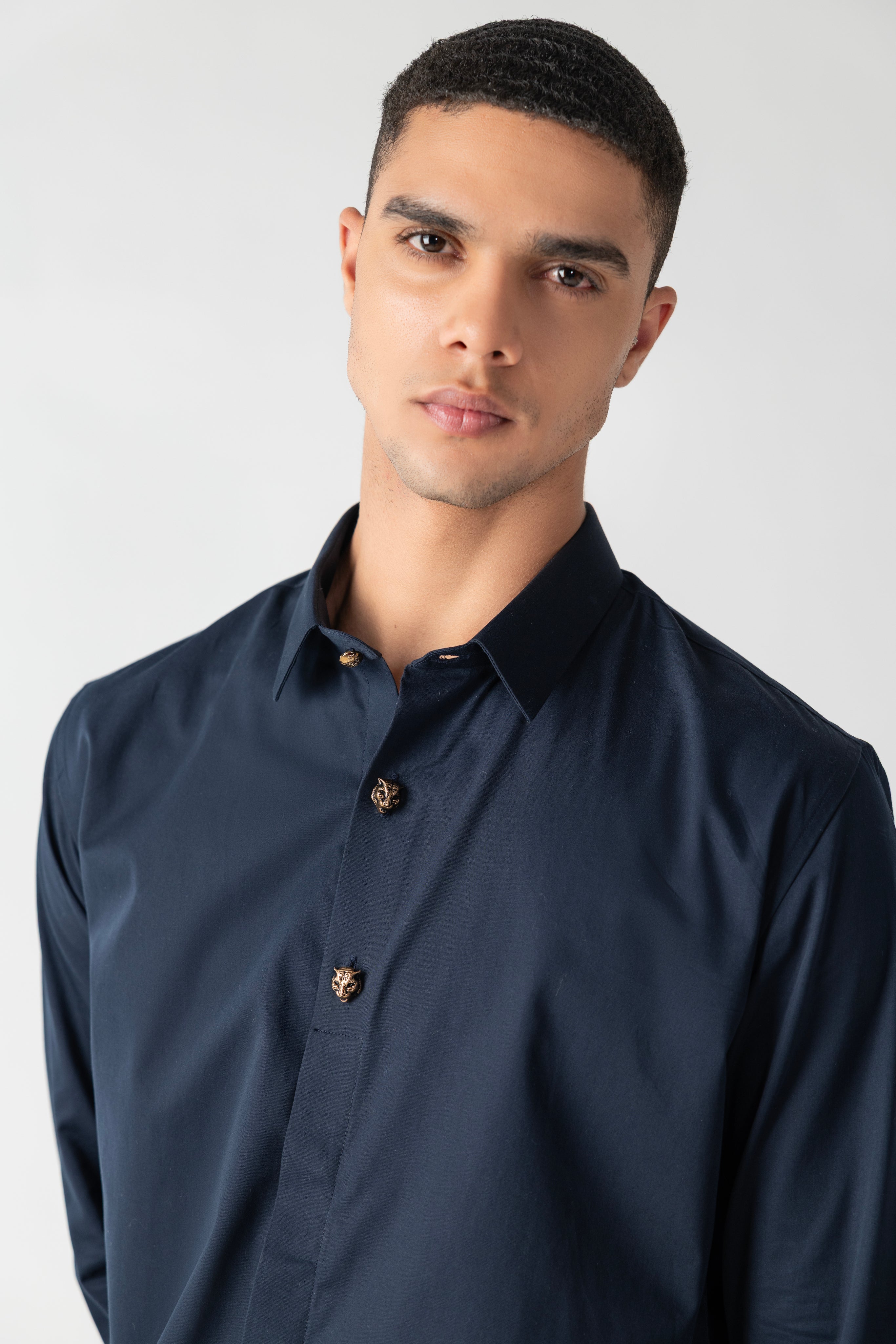 Navy blue hidden button placket shirt with leopard button detailing.