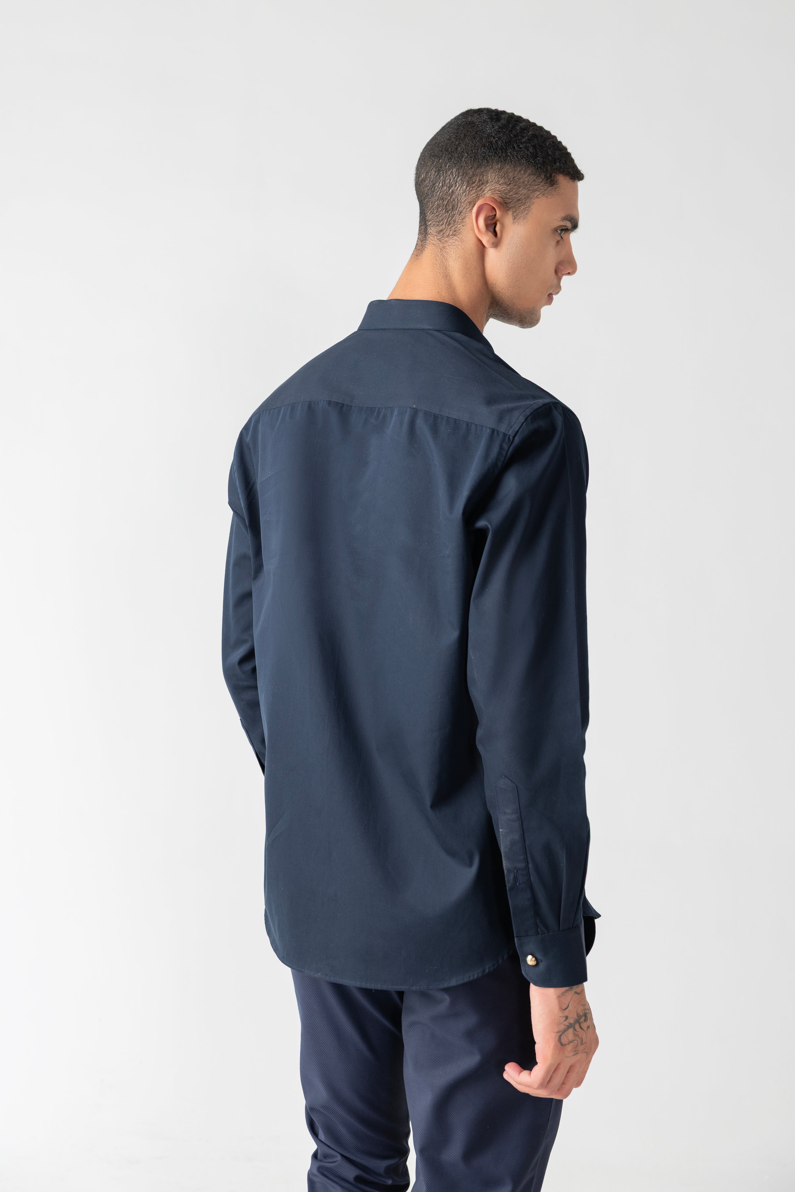 Navy blue hidden button placket shirt with leopard button detailing.