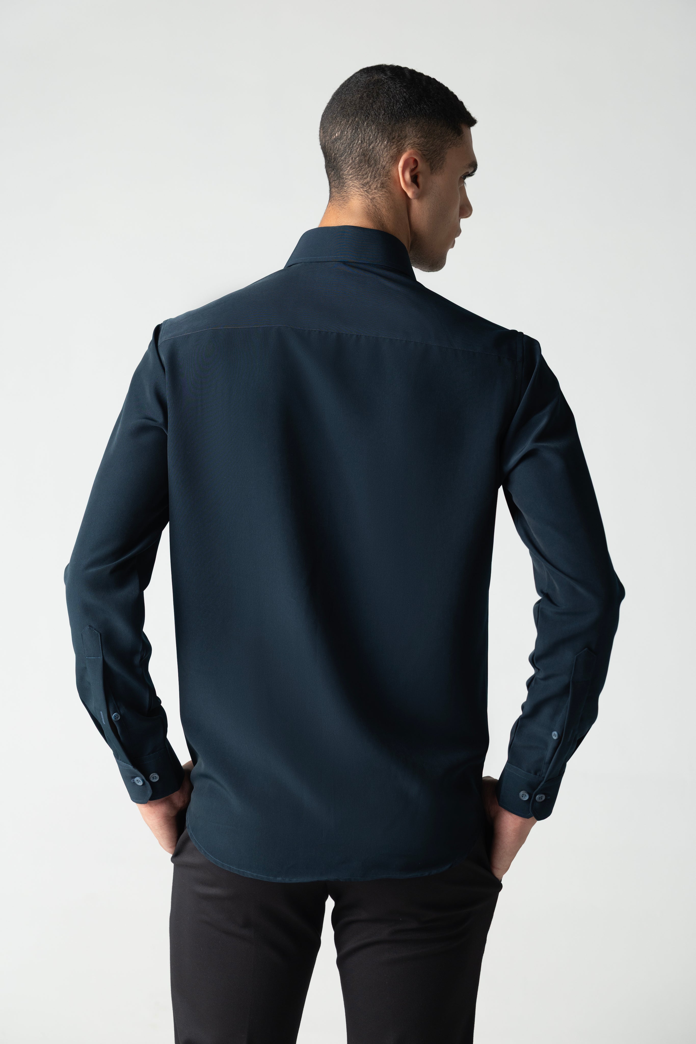 Turquoise shirt with hand-embroidered metal motif