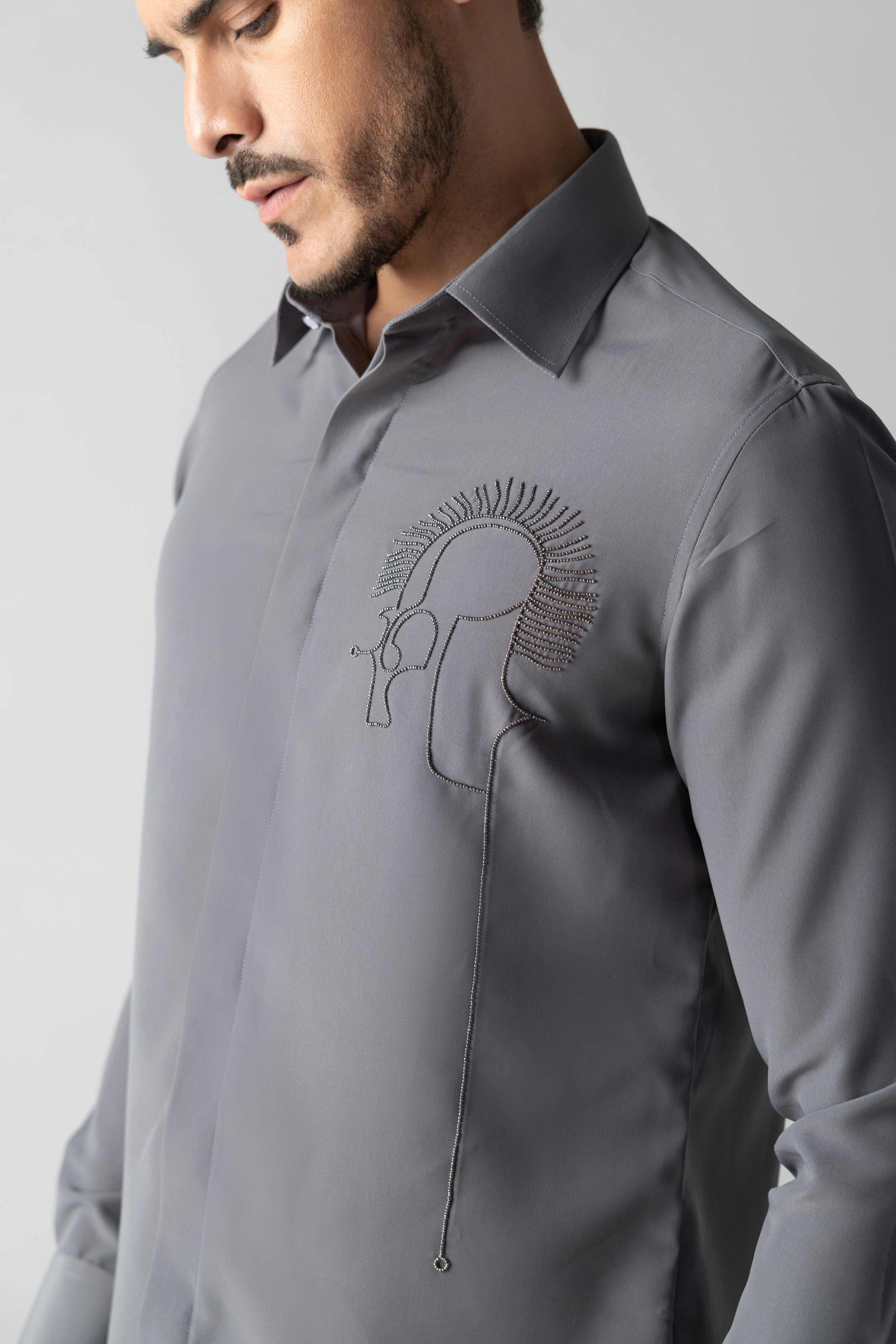 Grey shirt with abstract hand-embroidered metal motif