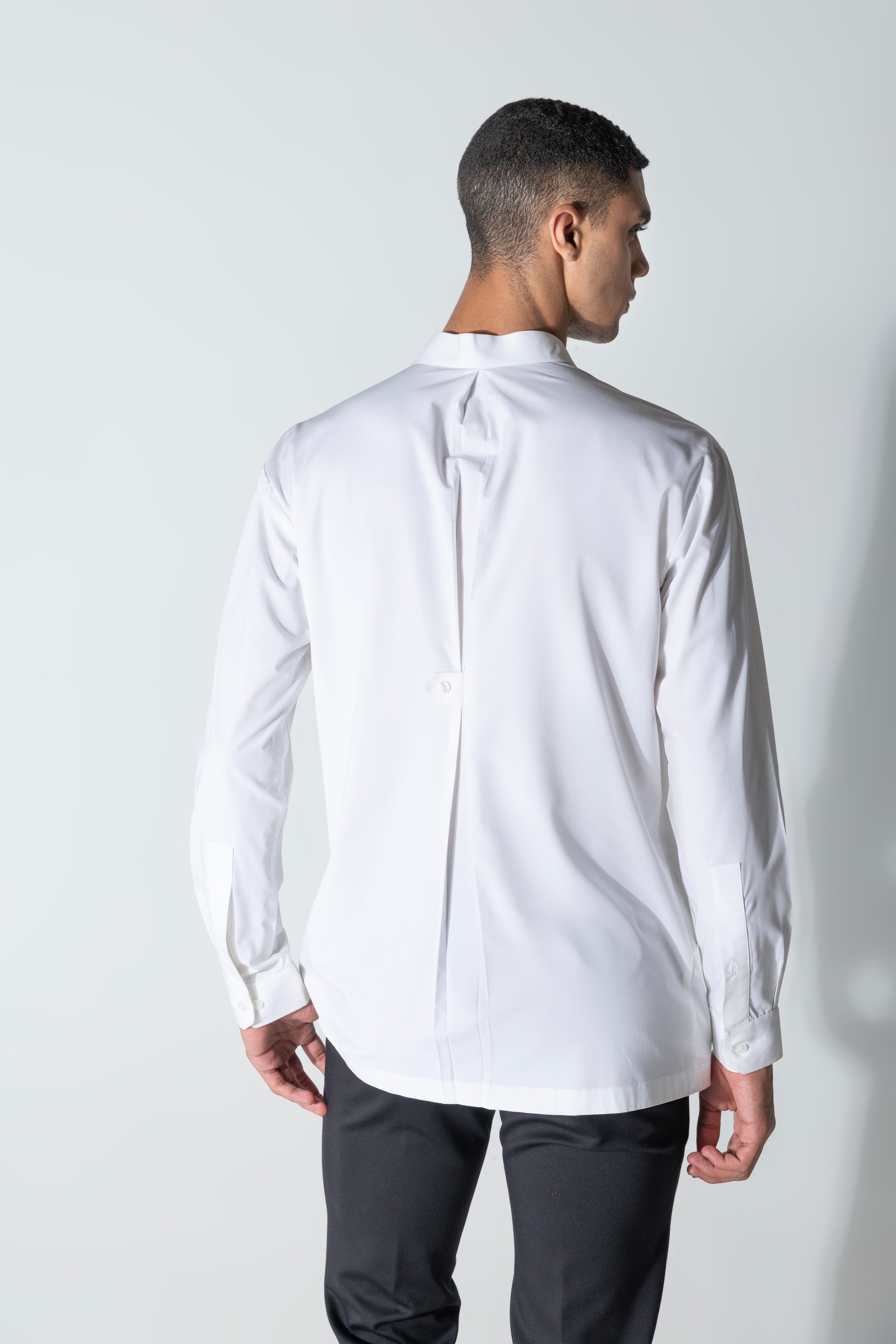 White shirt with asymmetrical cuts & drapes