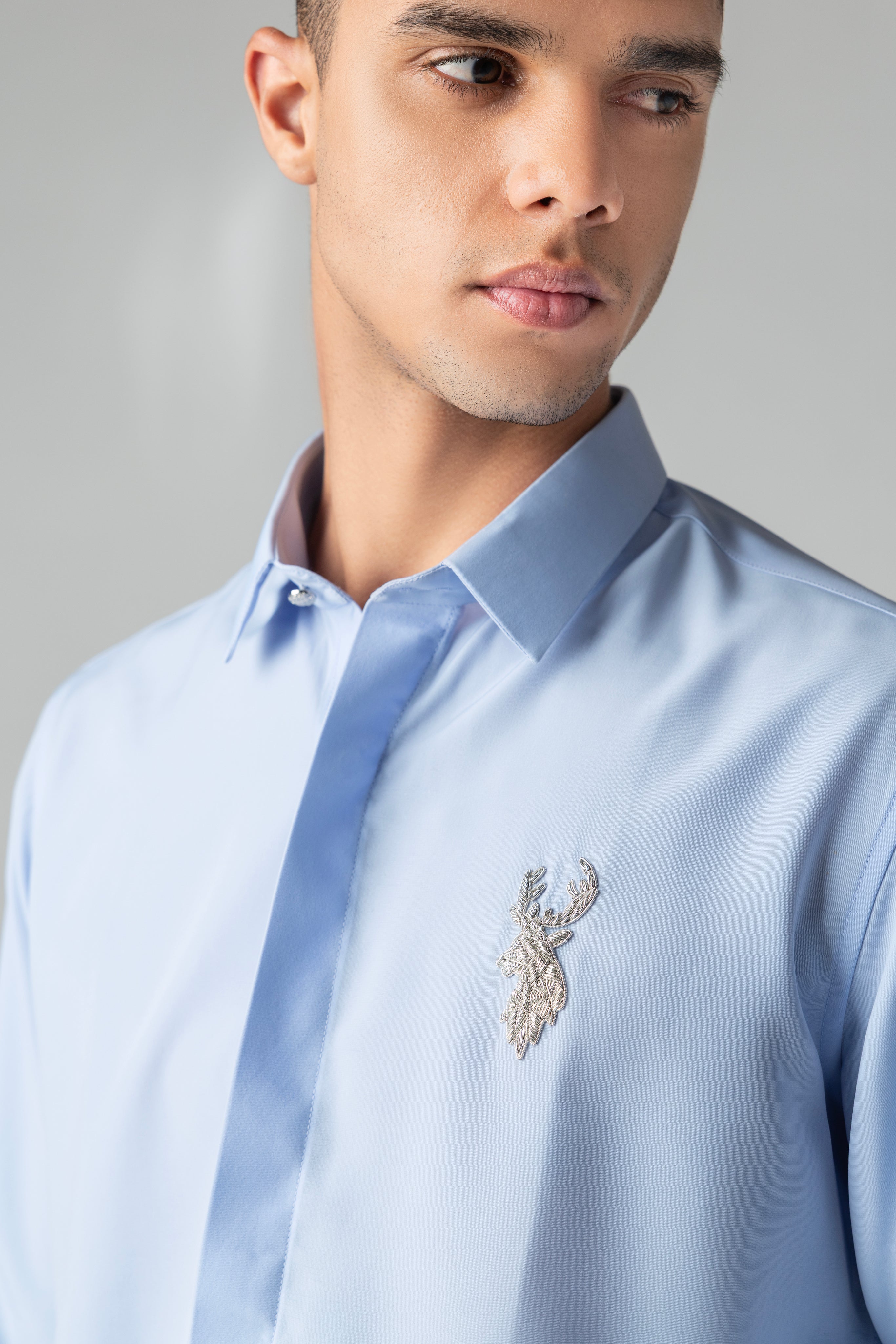Sky blue shirt with metallic hand-embroidered Reindeer motif