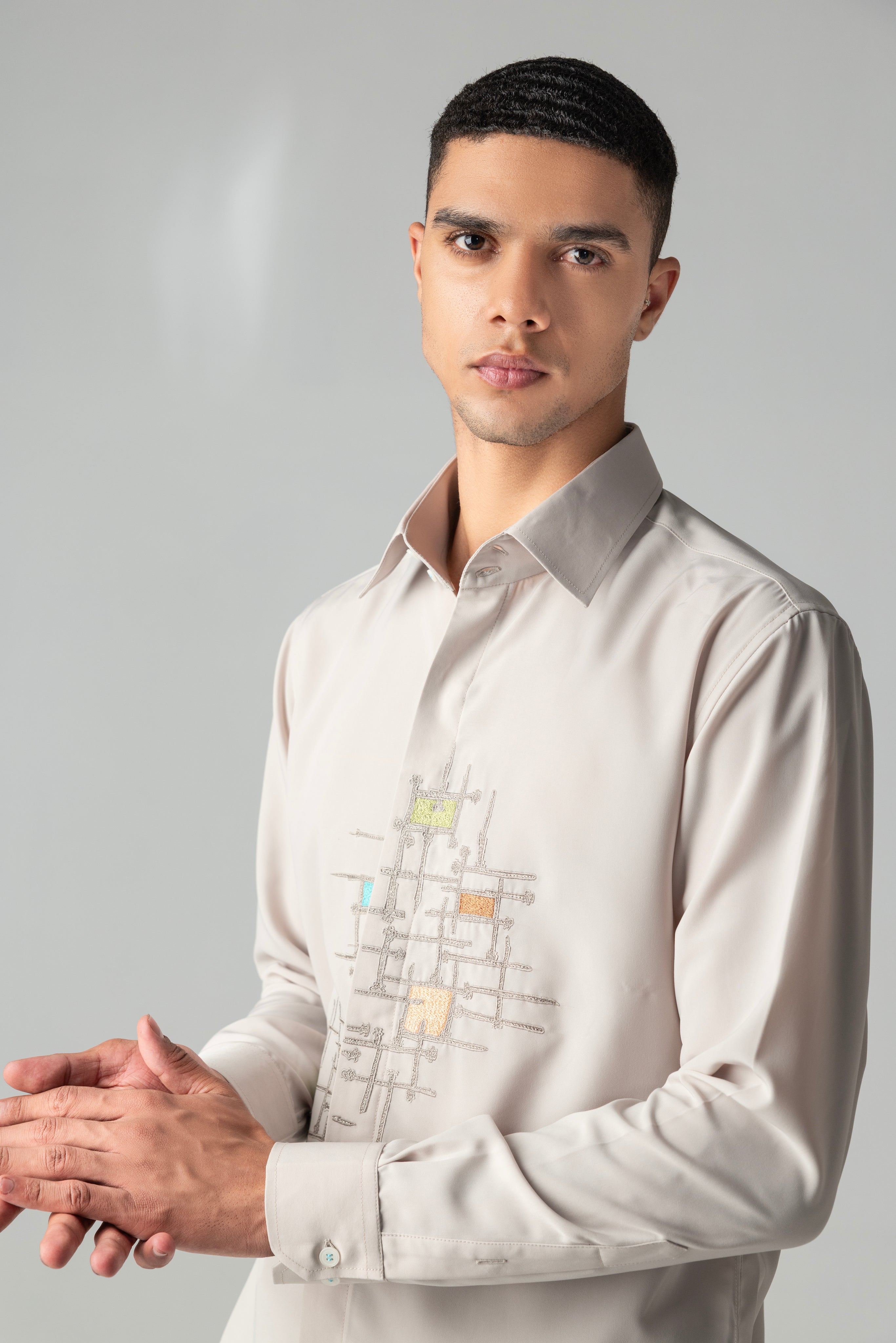 Beige shirt with abstract multi-coloured, geometrical embroidery