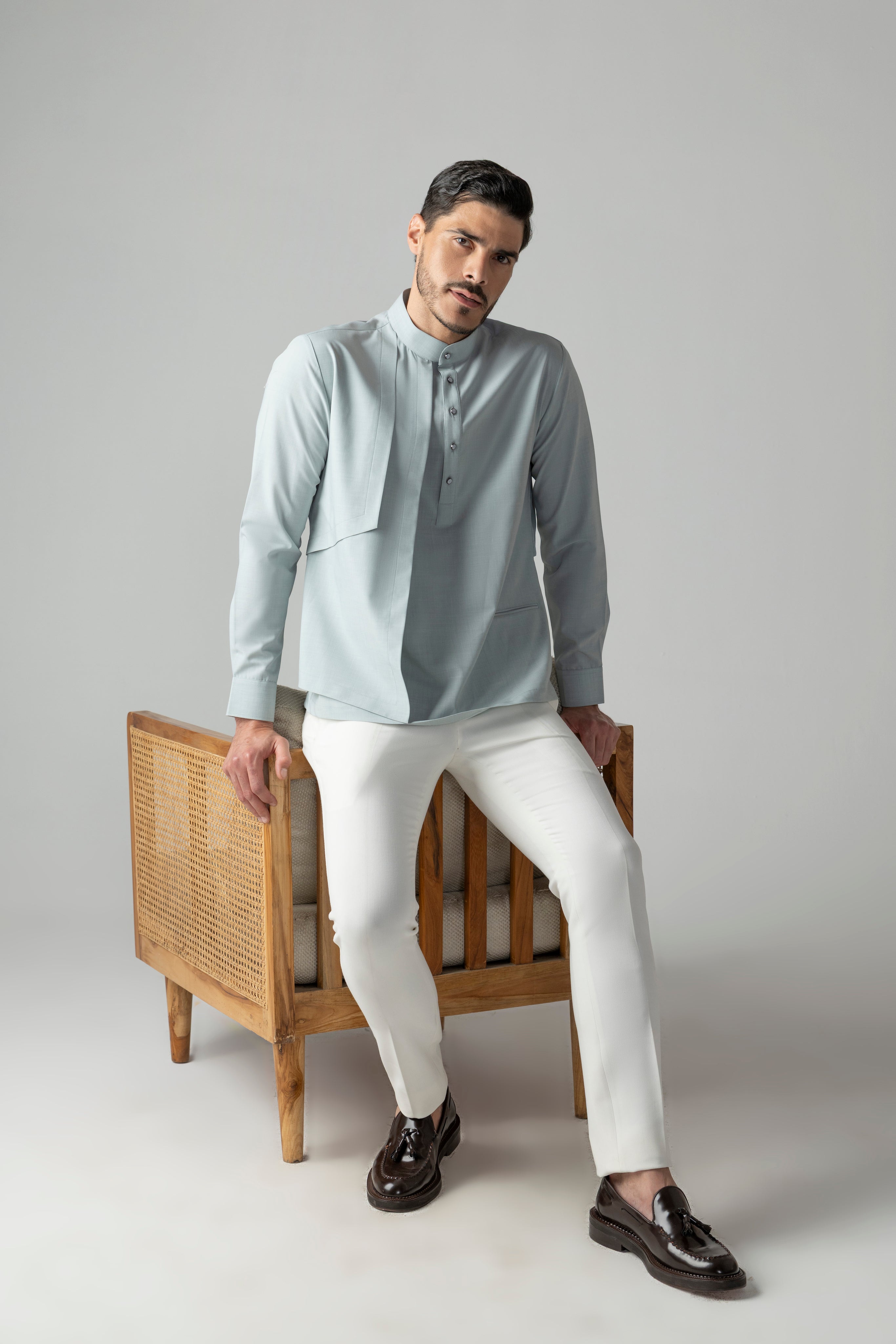 Light teal shirt with asymmetrical cuts & drapes