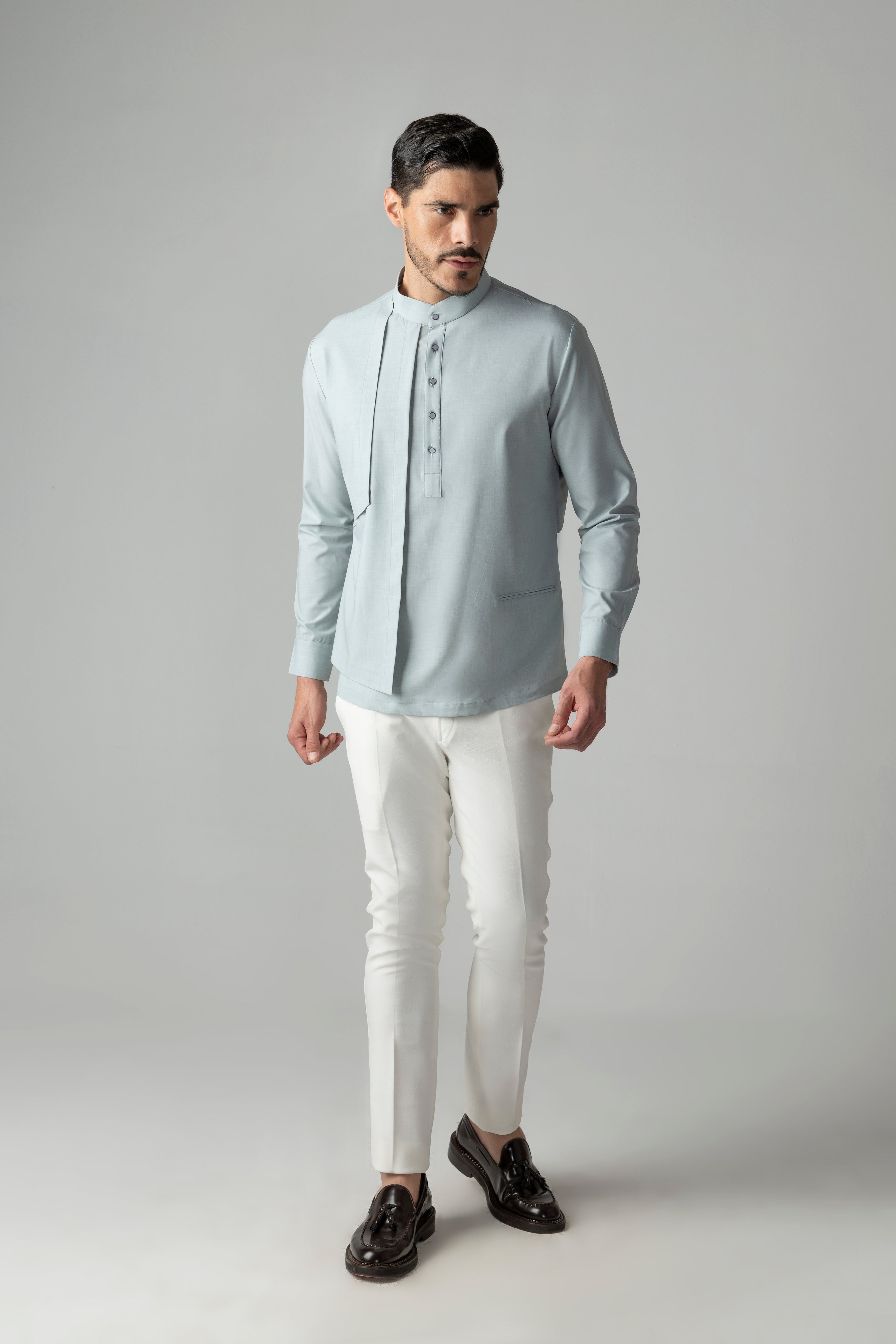 Light teal shirt with asymmetrical cuts & drapes