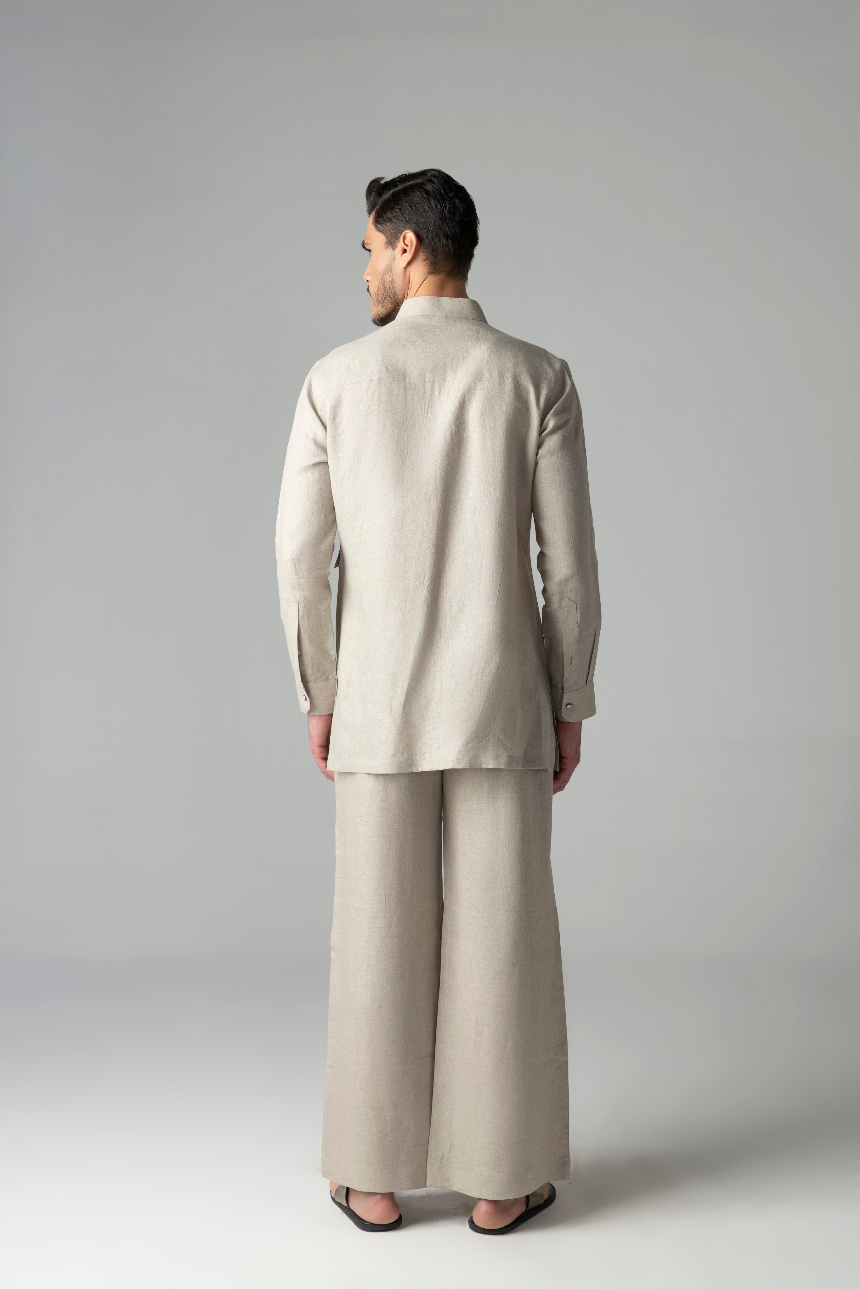 Beige linen short kurta with patch pocket detailing, paired with a matching plazzo
