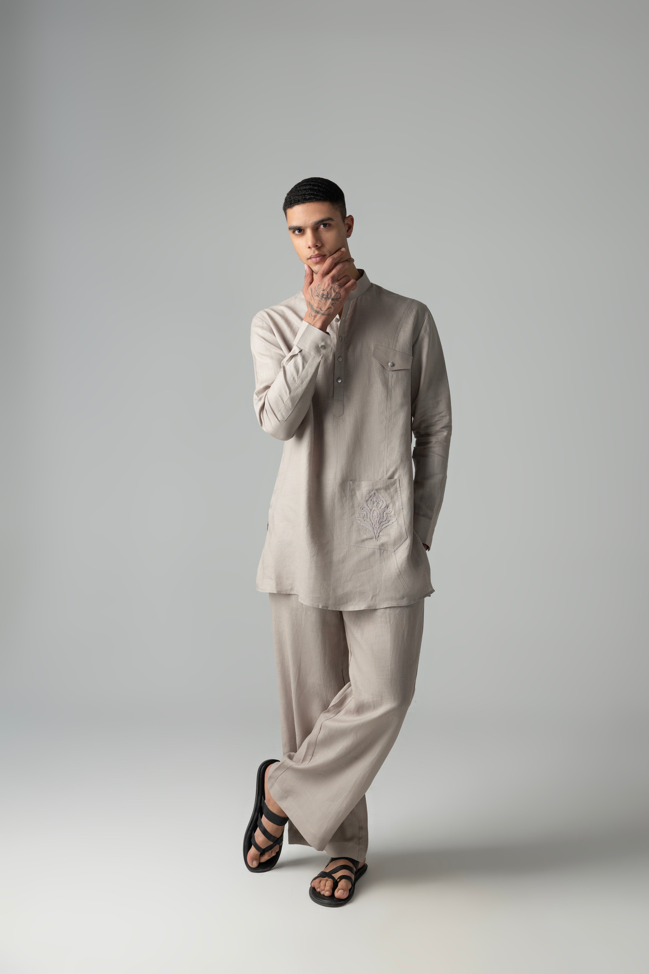 Beige short linen kurta with embroidered patch pocket detailing, paired with a matching plazzo