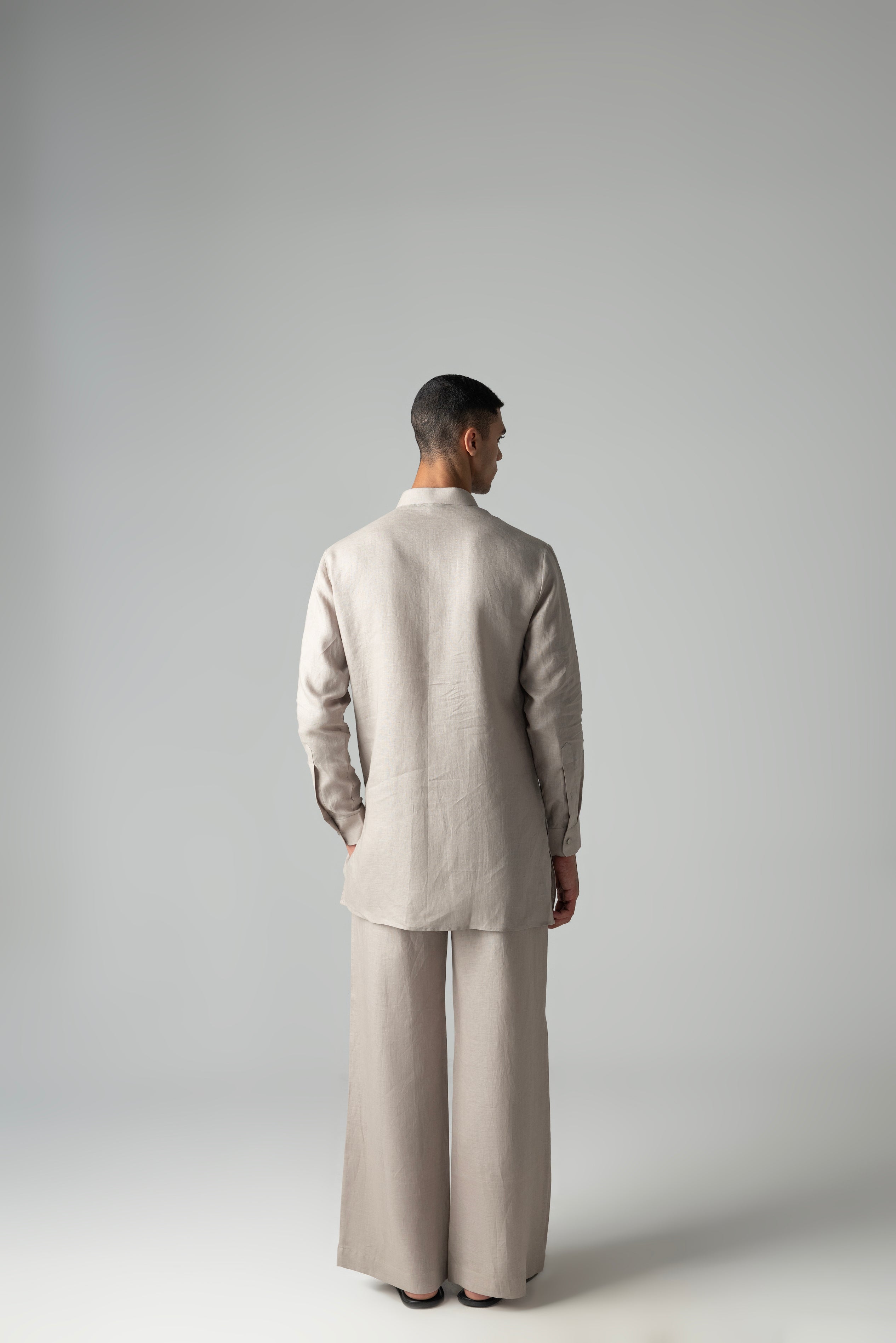 Beige short linen kurta with embroidered patch pocket detailing, paired with a matching plazzo