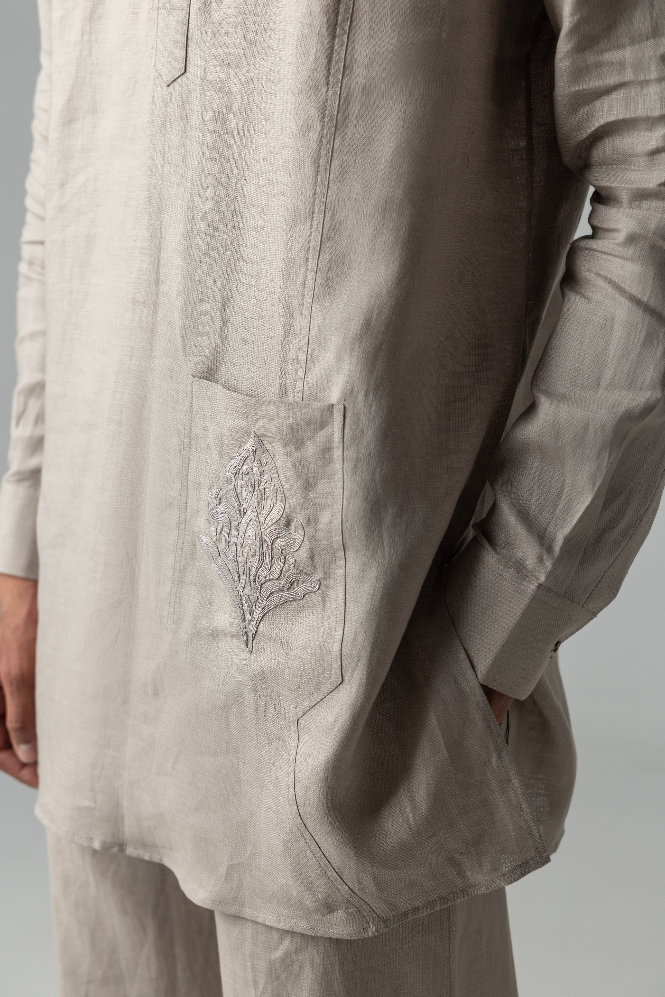 Beige short linen kurta with embroidered patch pocket detailing, paired with a matching plazzo