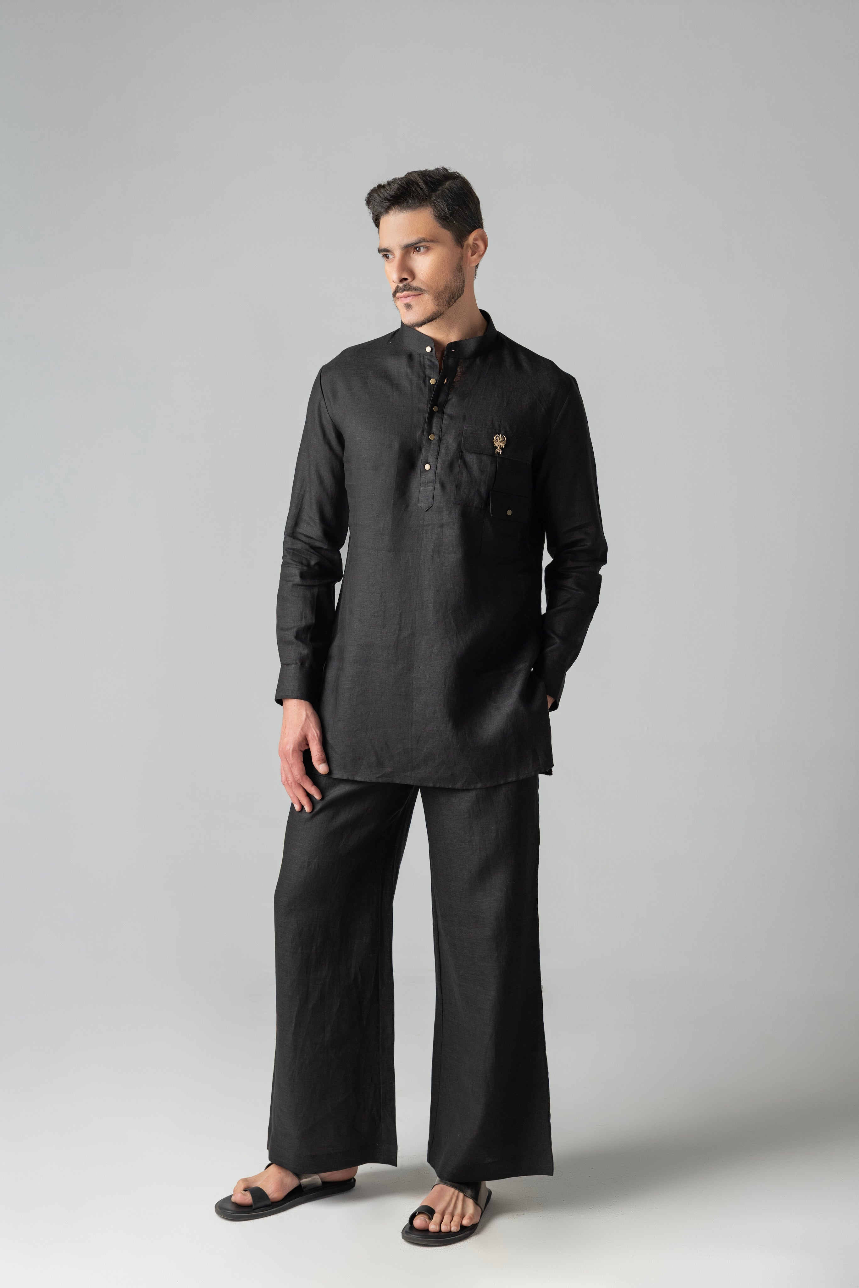 Black short linen kurta with patch pocket & brooch detailing, paired with a matching plazzo