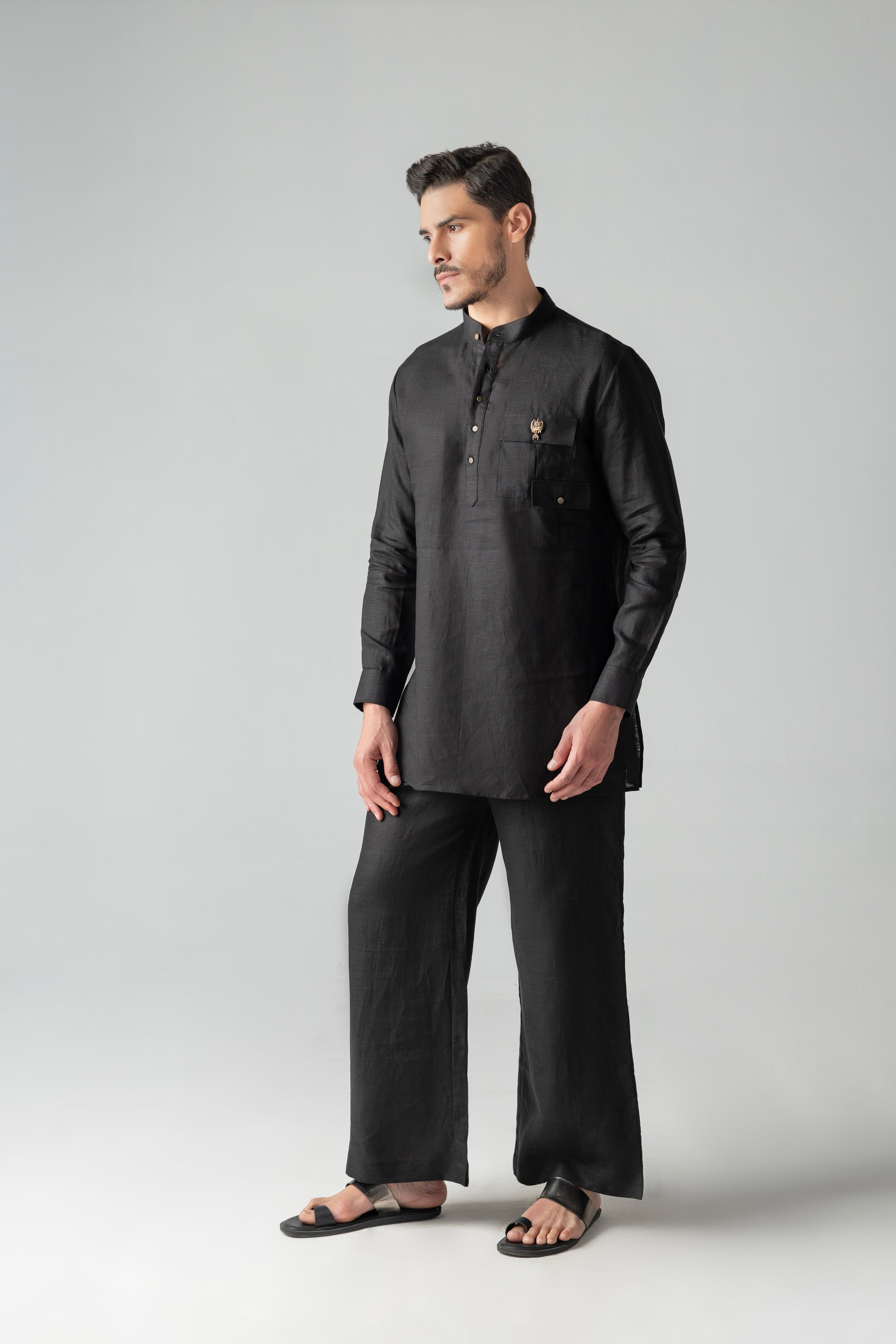 Black short linen kurta with patch pocket & brooch detailing, paired with a matching plazzo