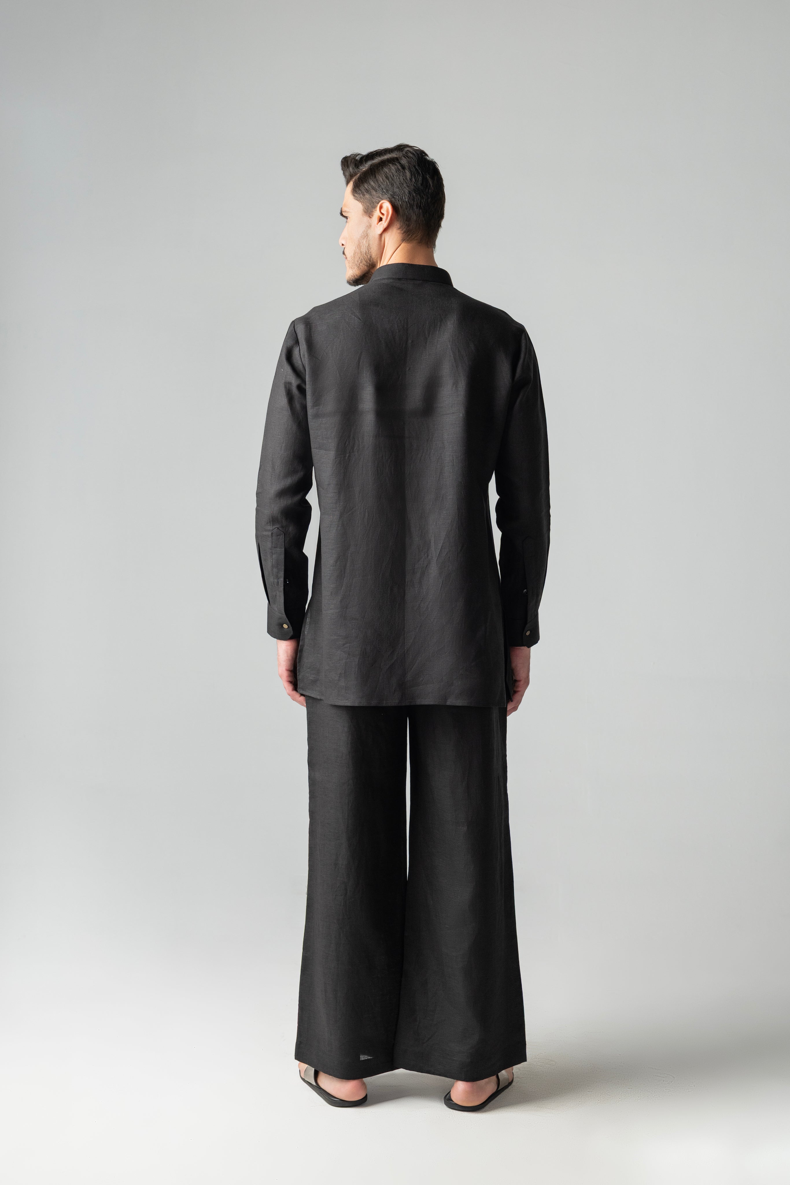 Black short linen kurta with patch pocket & brooch detailing, paired with a matching plazzo