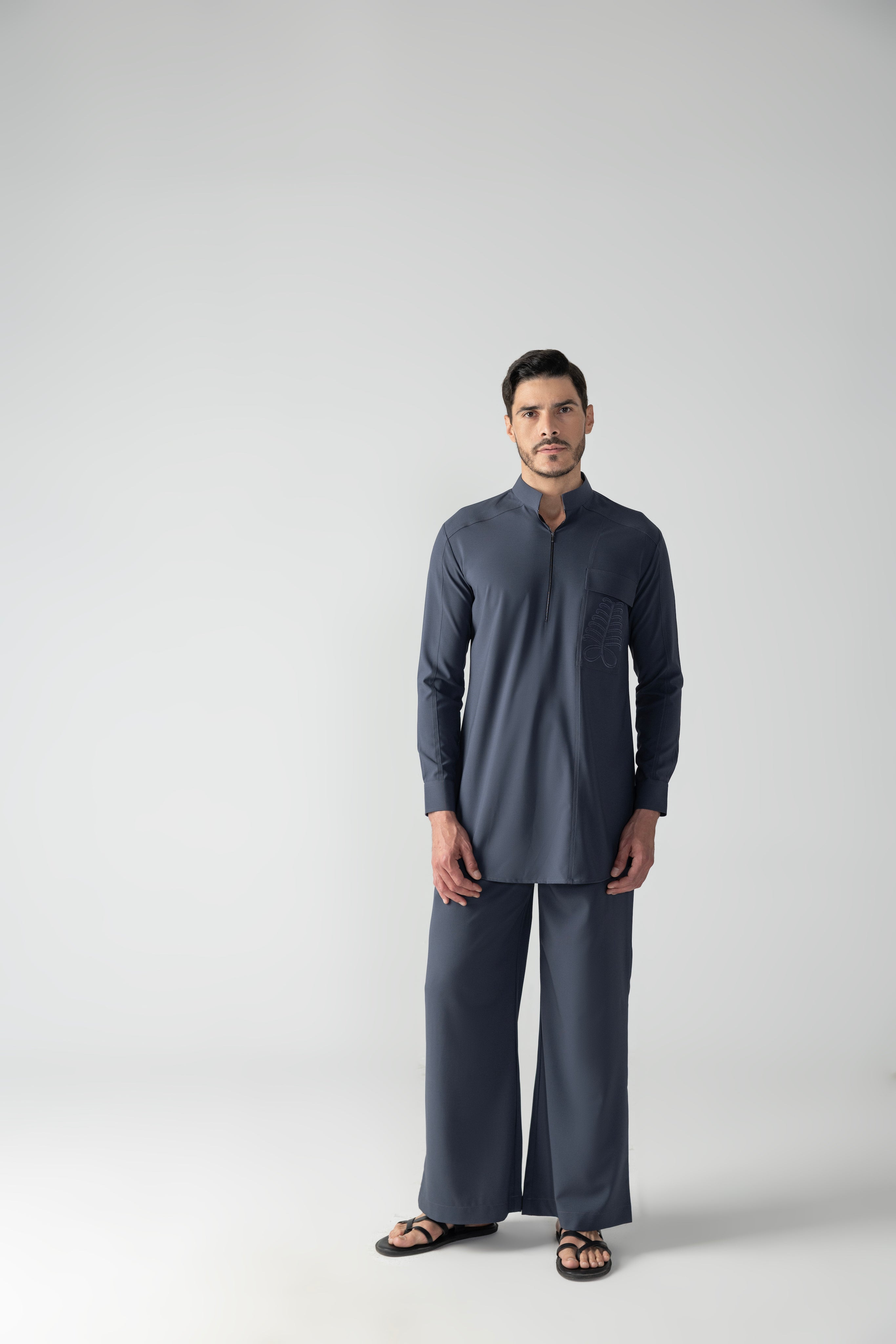 Dark grey short crepe kurta with embroidered patch pocket & zipper detailing, paired with a matching plazzo